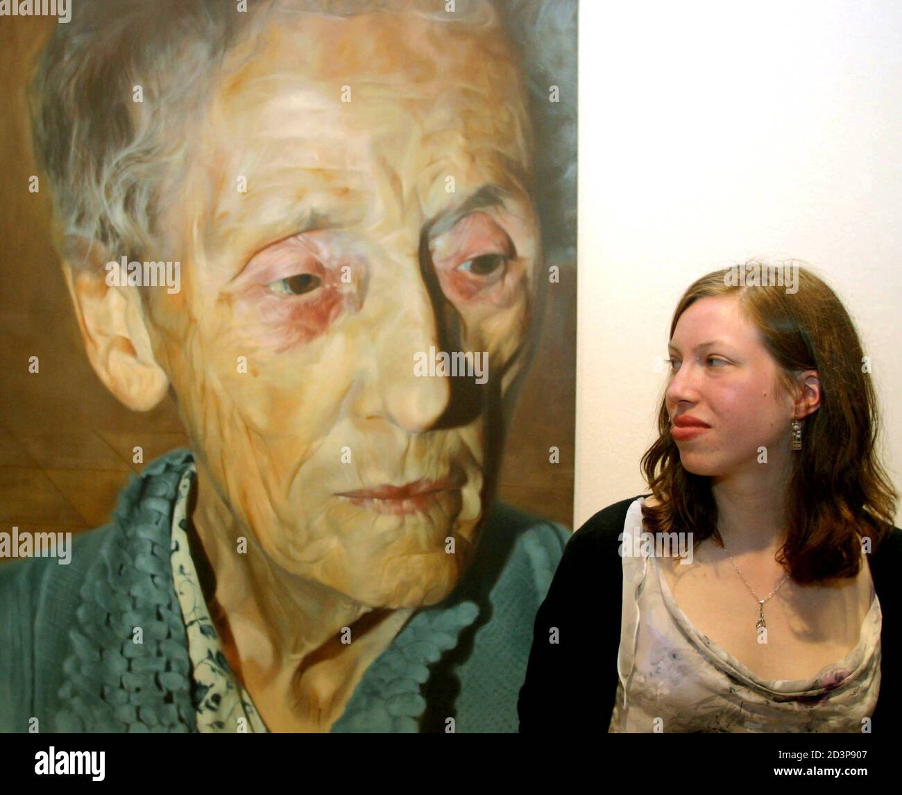 Charlotte Harris, winner of the 2003 BP Portrait Award, stands next to her untitled oil on canvas at the National Portrait Museum in London June 10, 2003. The 21-year old student was announced as the 25,000 pound sterling winner of the award on Tuesday night with her painting of her grandmother Doris Davis. Stock Photo