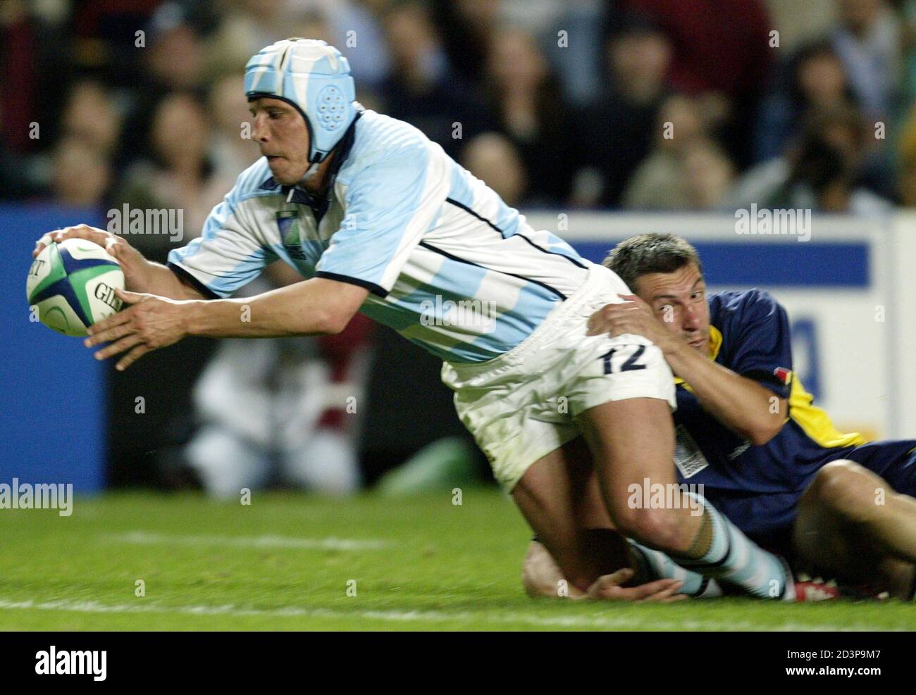 Argentina's Manuel Contepomi breaks past Romania's Mihai Vioreanu to score  during their 2003 Rugby World Cup