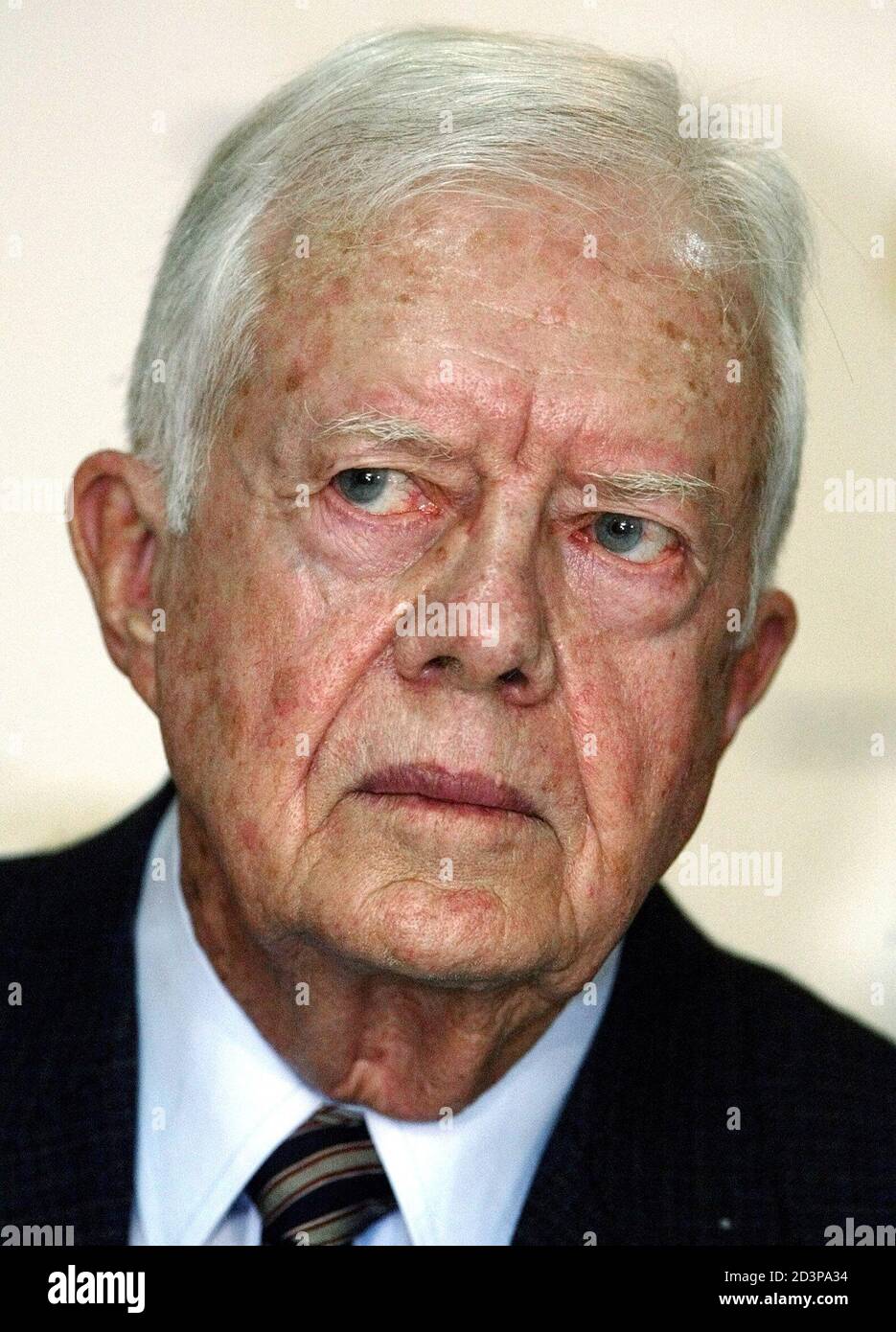 Former U.S. President Jimmy Carter listens to journalists during a press conference in Caracas, January 27, 2004. Venezuelan President Hugo Chavez told Carter he would submit to a recall vote, if required, and allow foreign observers to check the electoral process - 'even under the carpet.' After talks in Caracas with the 2002 Nobel Peace Prize winner, Chavez said he would allow observers from the Organization of American States and the Carter Center to scrutinize every detail of the referendum process. REUTERS/Jorge Silva  JS/HB Stock Photo