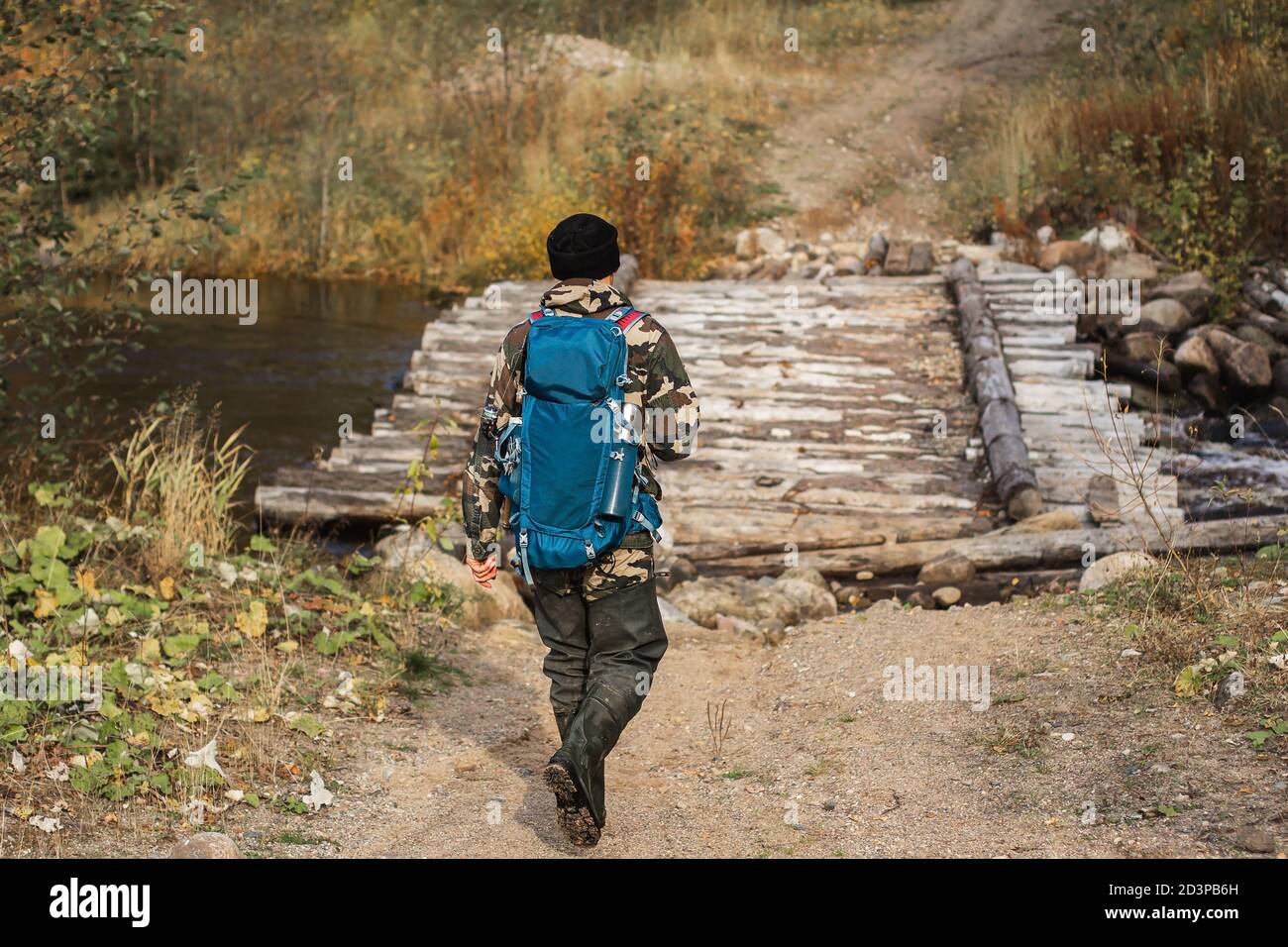 back view photo of male backpacker walking on forest path and viewing  landscape in autumn vacation Stock Photo - Alamy