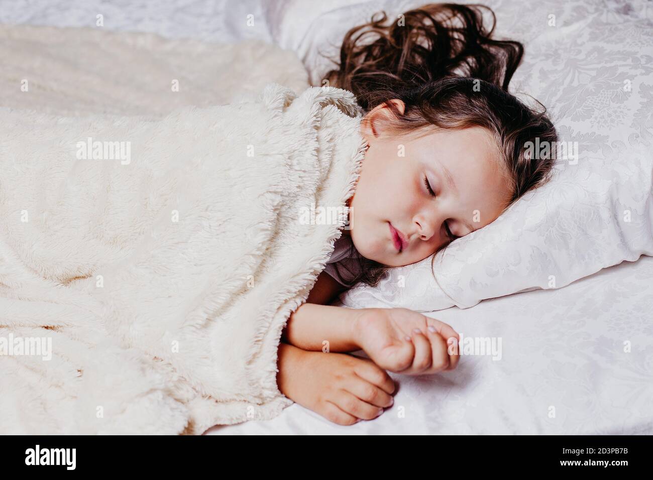 a fiveyearold girl sleeps peacefully on an orthopedic pillow, home