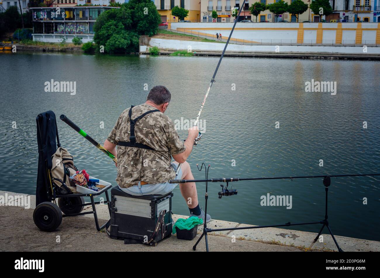 Back view of a fisherman in the Guadalquivir river Stock Photo