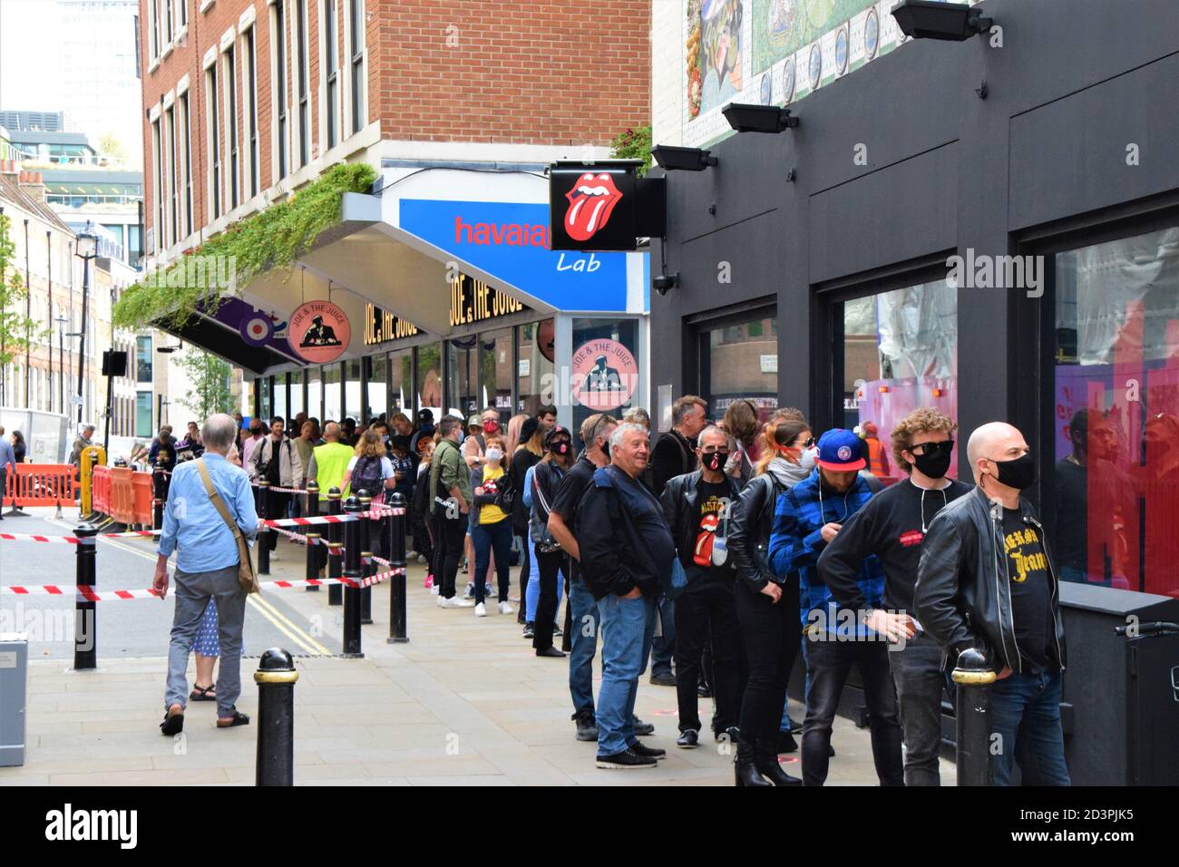 People queuing on opening day of the world's first Rolling Stones store on Carnaby Street, London Stock Photo