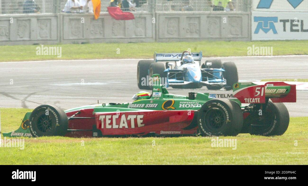 2002 Cart series Luis Miguel Diaz of Mexico sits in his car (bottom) as  Patrick Carpentier of Canada drives past during morning training for the  Mexico Grand Prix, at the Hermanos Rodriguez