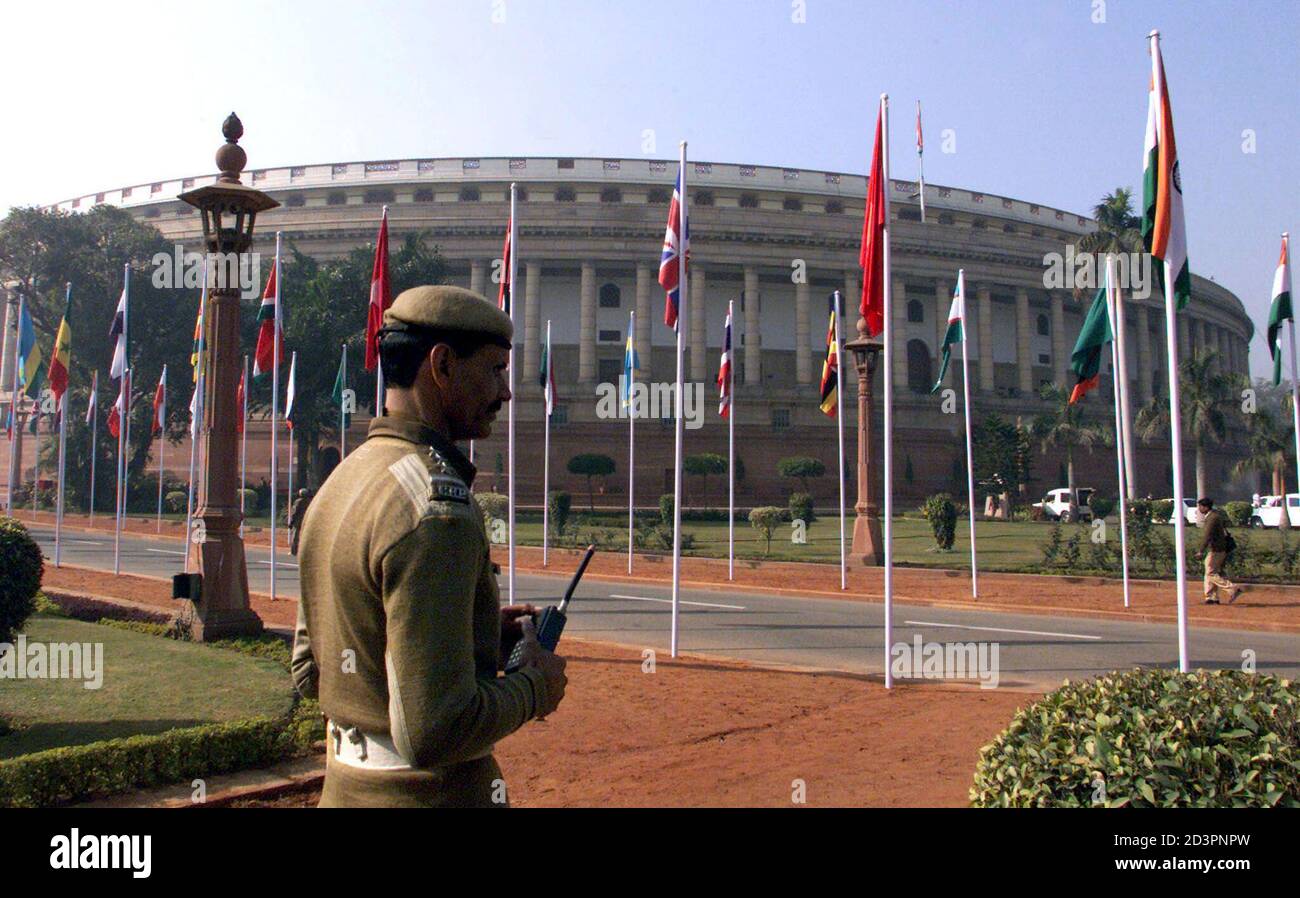 An Indian security official stands guard outside the Indian Parliament building in New Delhi January 22, 2003. The Indian Parliament building, which was created by British designer Sir Edward Lutyens, celebrated its golden jubilee on Wednesday with a release of book on the subject and military bands taking part in the festivities. Stock Photo