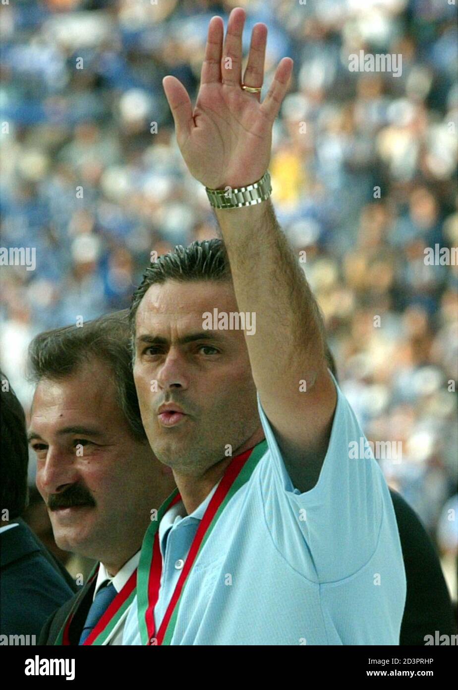 Porto Soccer Coach Jose Mourinho R Waves To The Crowd Accompanied By Team Director Reinaldo Telles At The End Of The Portuguese Soccer Cup Final Held In Jamor Stadium June 15 2003