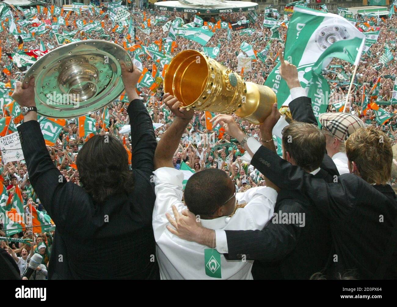 PLAYERS OF GERMAN SOCCER CHAMPION WERDER BREMEN CELEBRATE WITH THE  BUNDESLIGA TROPHY AND THE GERMAN SOCCER CUP IN BREMEN. Werder Bremen's  (L-R) Uemit Davala from Turkey, Ailton from Brazil, Fabian Ernst, Pekka