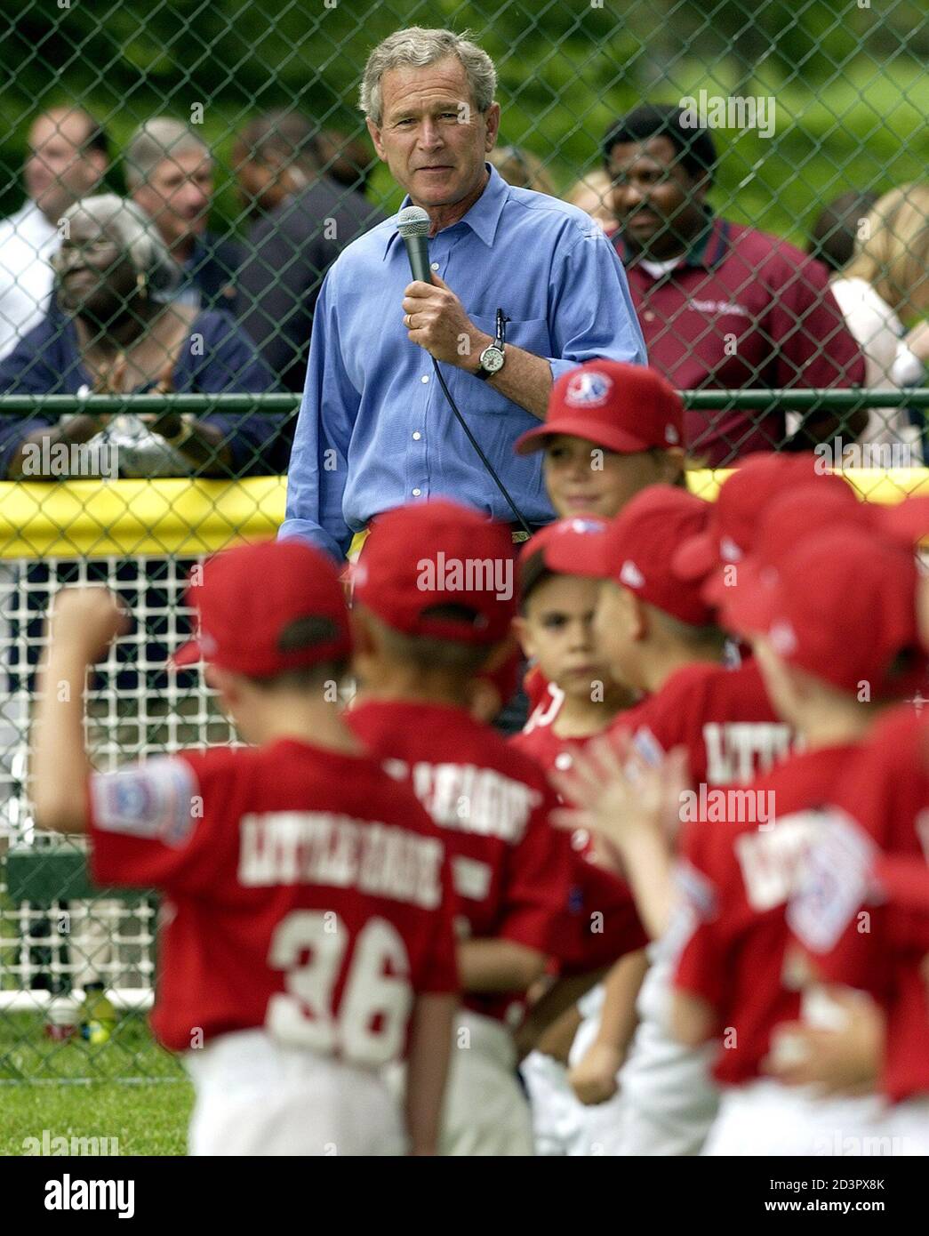 U.S. President George W. Bush welcomes the Cherry Point Marine Corps Air Station Devil Dogs to the annual Tee Ball event on the South Lawn of the White House in Washington, D.C., June 13, 2004. The President and First lady hosted the annual Tee Ball on the South Lawn after a busy week of events in the nation's capitol. REUTERS/Mannie Garcia  MG Stock Photo