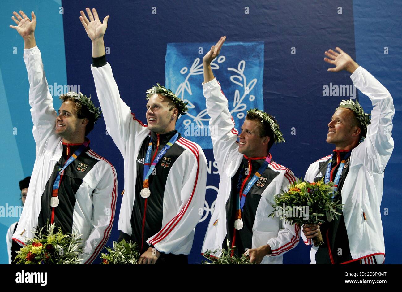 The silver medal winning German medley relay team (L-R) Steffan Driesen,  Jens Krippa, Thomas Ruppruth and Lars Conrad wave after receiving their  medals on the podium at the Olympic Aquatics Center in