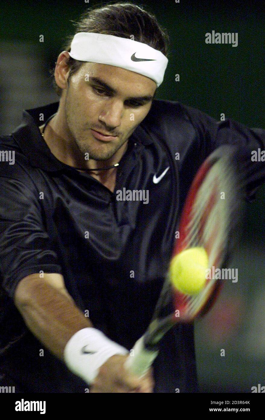 Switzerland's Roger Federer plays a backhand during his fourth round match  against Germany's Tommy Haas at the Australian Open in Melbourne January  21, 2002. Haas won in five sets 7-6 4-6 3-6