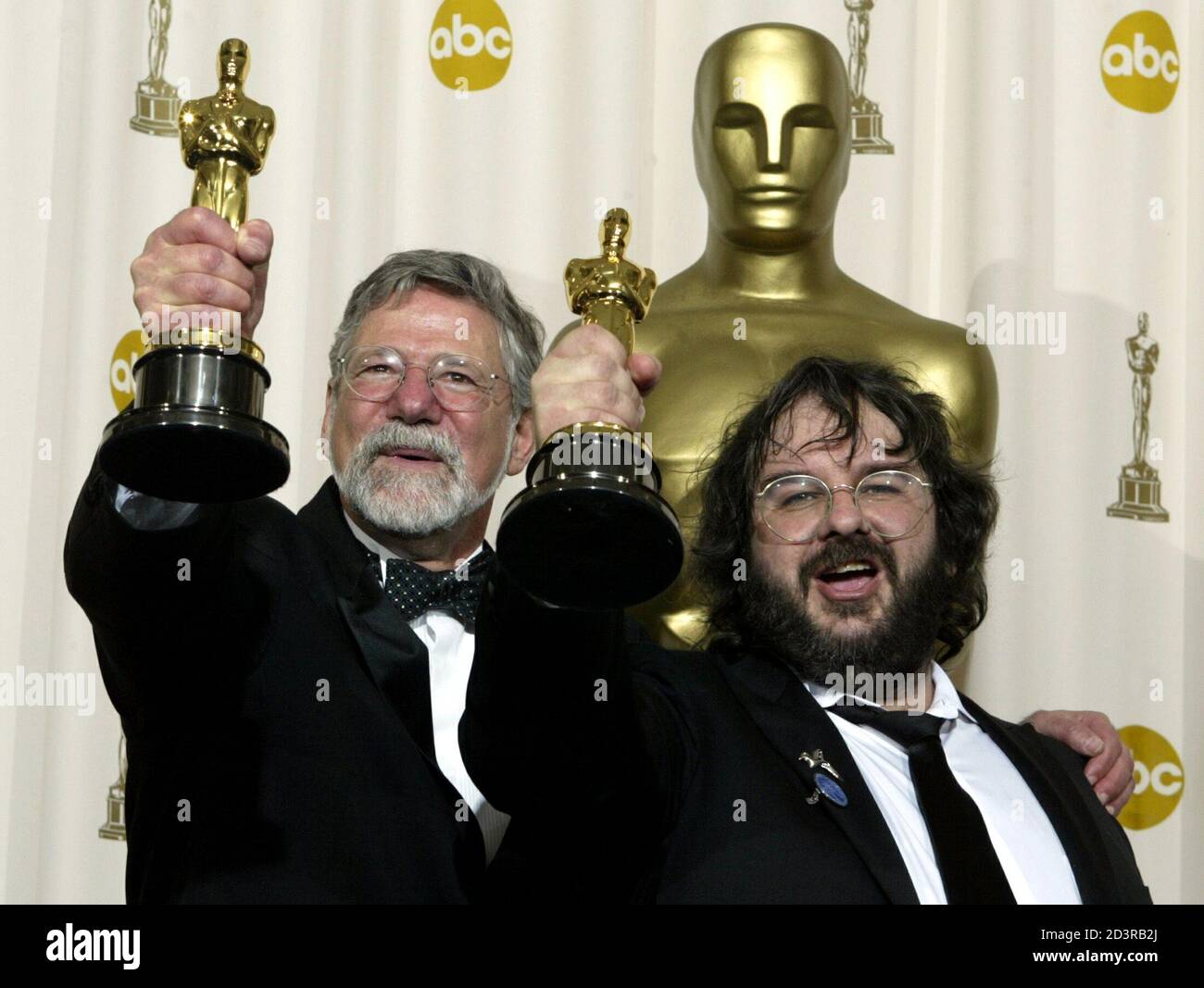 Producer/Director Peter Jackson (R) of New Zealand, and fellow producer  Barrie Osbourne with their Oscar statues after "The Lord of the Rings: The  Return of the King" won the Oscar for best