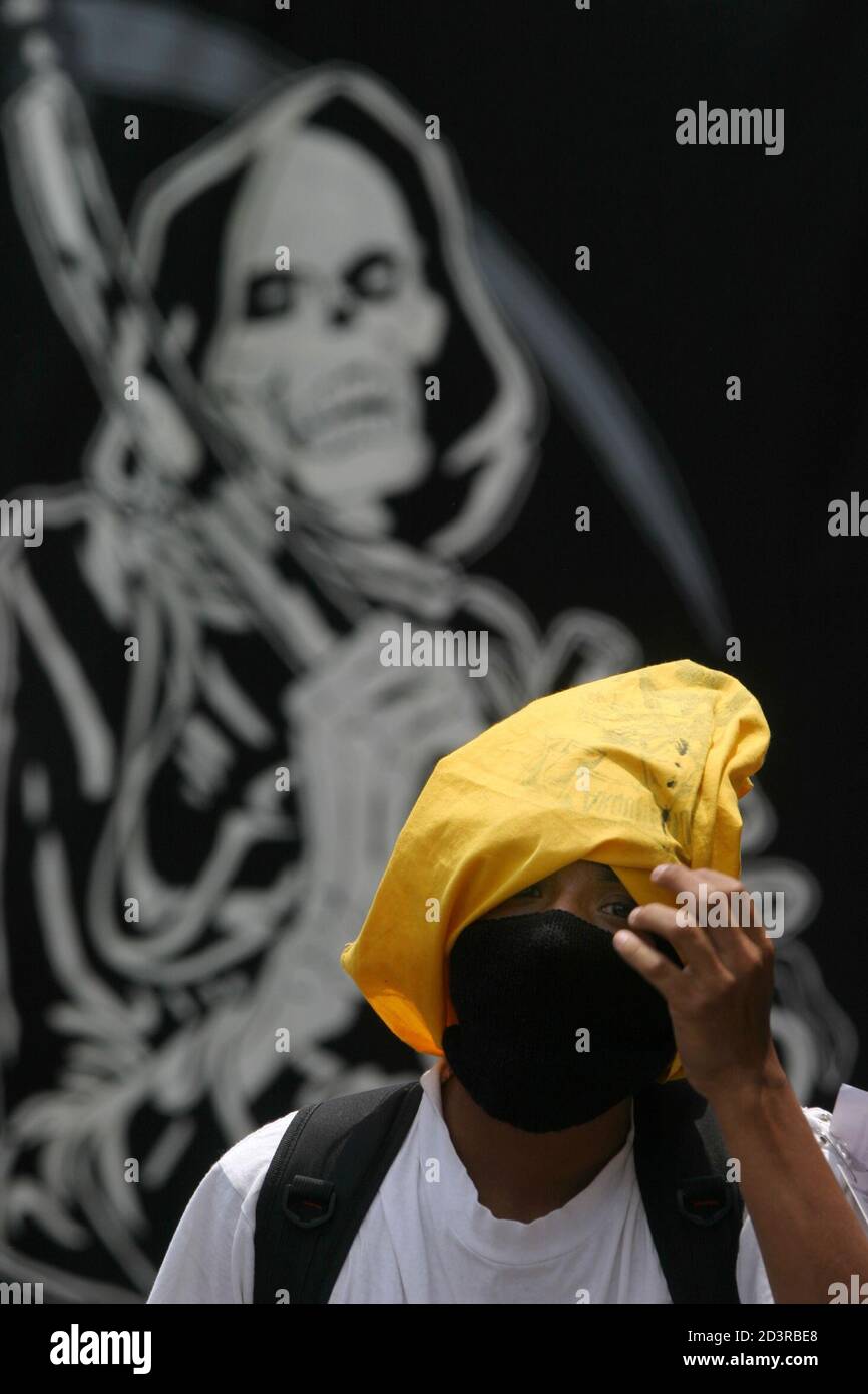 A student from the University of San Carlos fixes his mask during the annual 'Huelga de los Dolores' parade, April 2, 2004 in Guatemala City. The event, a tradition for 106 years, is now used by the students as a chance to air their grievances against the government. REUTERS/Daniel LeClair  DNL Stock Photo