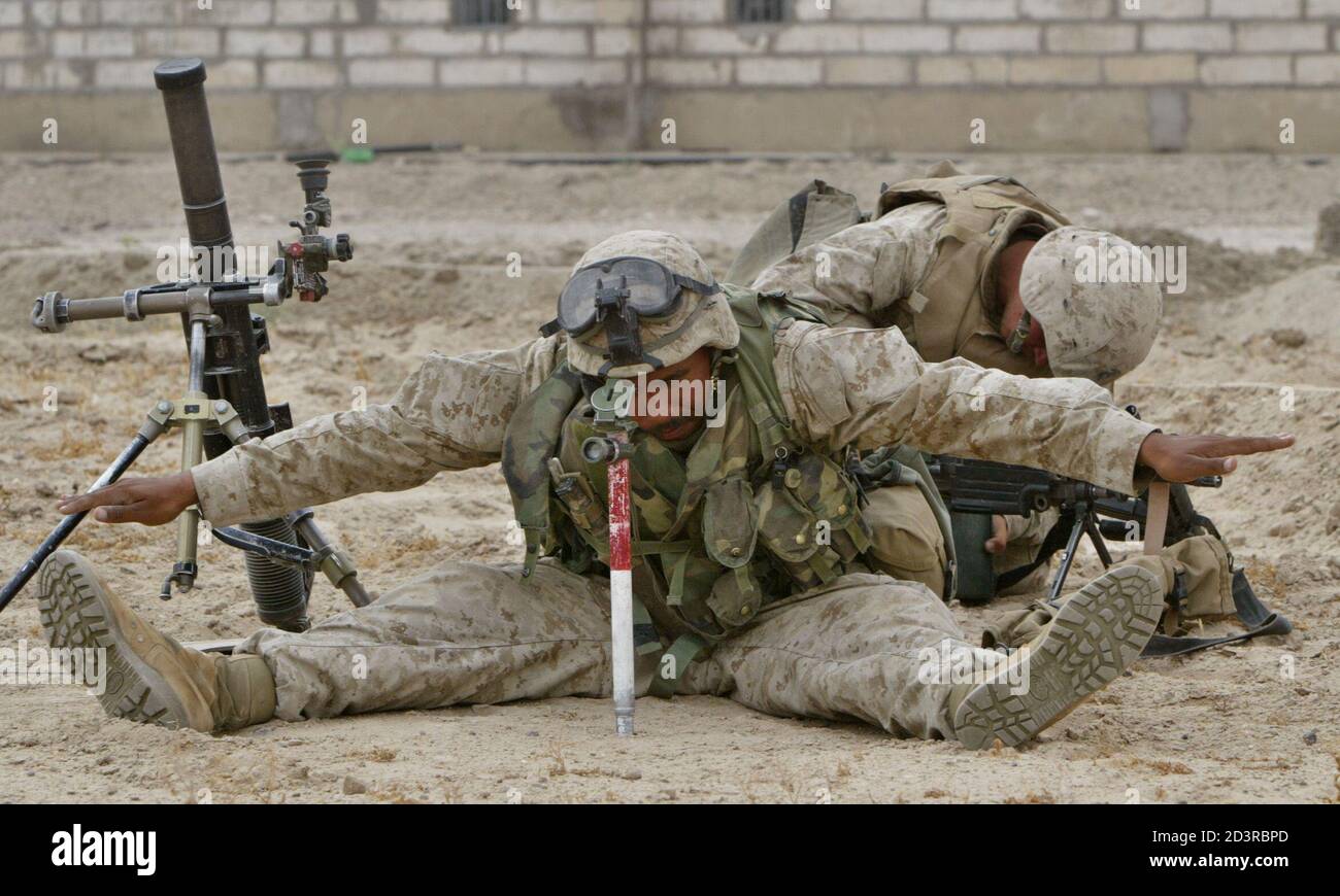 U.S. marines from Gulf Company, 2nd Battalion, 1st Marine Expeditionary Force prepare their mortar position near the town of Falluja on April 29, 2004. REUTERS/Oleg Popov  OP/THI Stock Photo