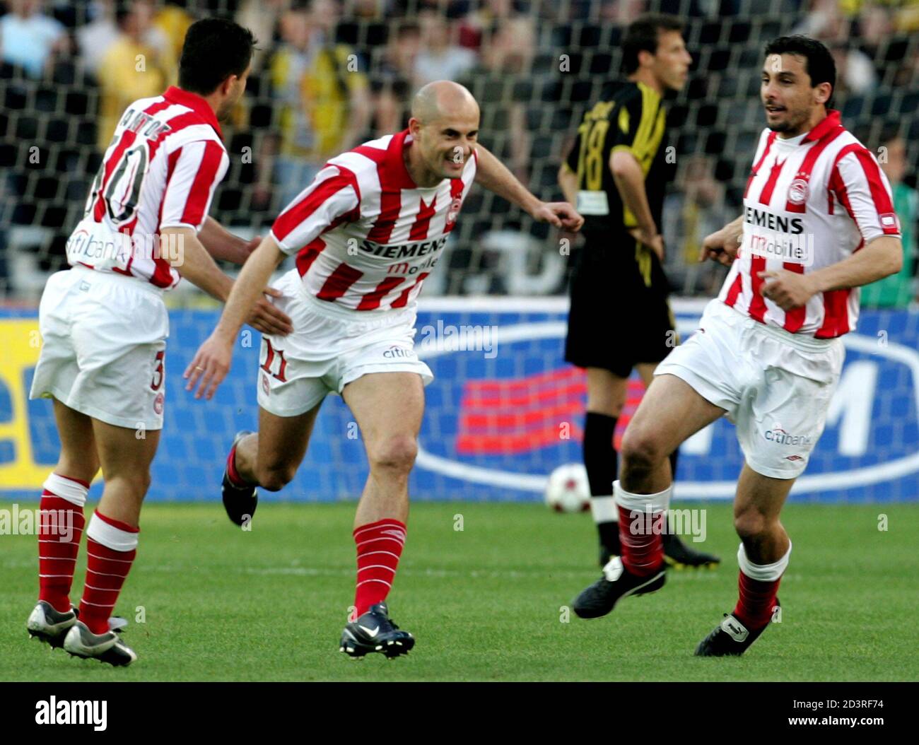 Olympiakos' Djordjevic celebrates after scoring against AEK Athens during a  Greek Cup semi-final match in Athens. Olympiakos' Predrag Djordjevic (C)  celebrates with his team mates Tasos Pantos (L) and Ieroklis Stoltidis after