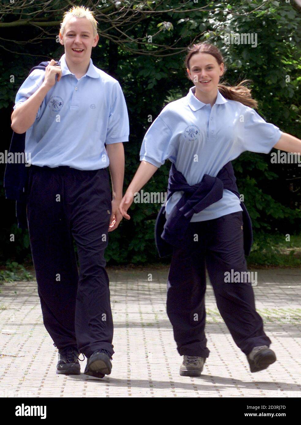 Fourteen-year-old Andy Benn (L) and 15-year-old Linda Rahl (R) pose wearing their brand new school uniform, which is being piloted at the Willi-Graf-Oberschule in Berlin May 21, 2001. The uniform trial starts today in two classes of this school and runs until the beginning of the summer holidays. Pupils at German state schools do not wear uniforms.  AX/JOH Stock Photo