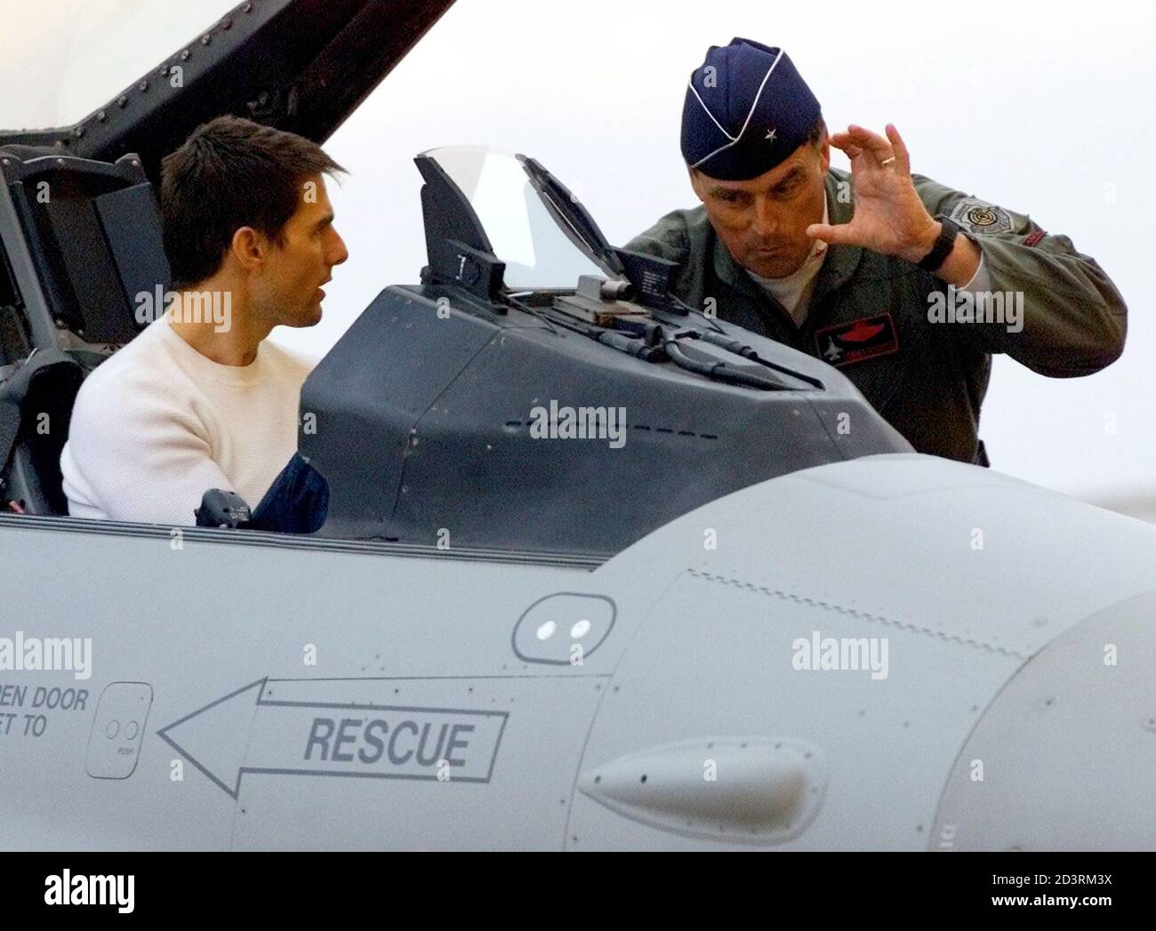 Actor Tom Cruise talks with an U.S. Air Force pilot as he sits in the  cockpit of an F-16 fighter at the Naval Air Station Joint Reserve Base/Fort  Worth in Fort Worth,