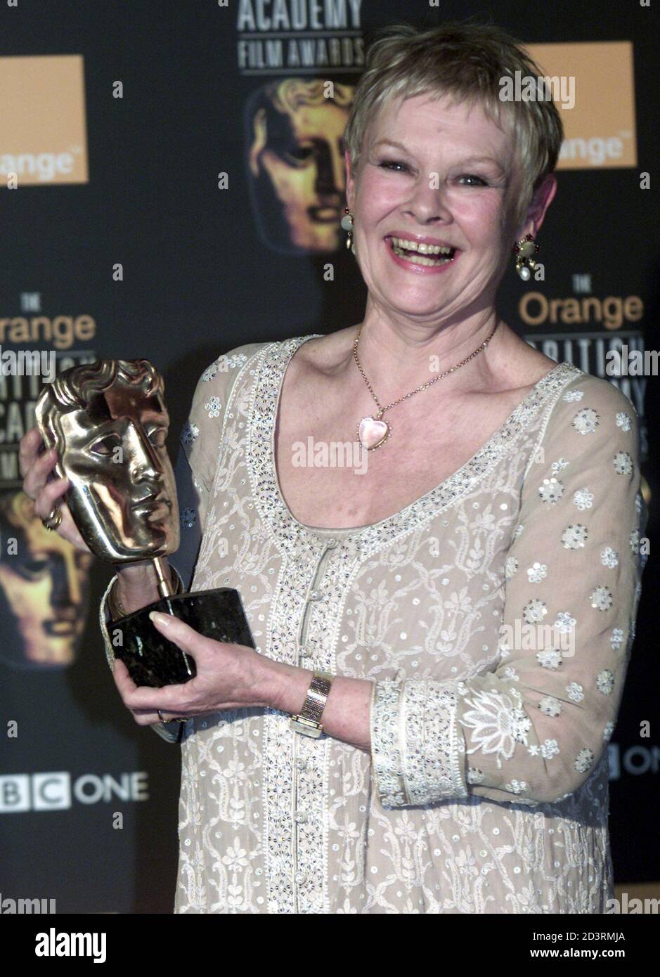 British actress Dame Judi Dench receives the British Academy best actress award for playing another damaged genius with  her memorable portrayal of writer Iris Murdoch 'sliding into the Stock Photo