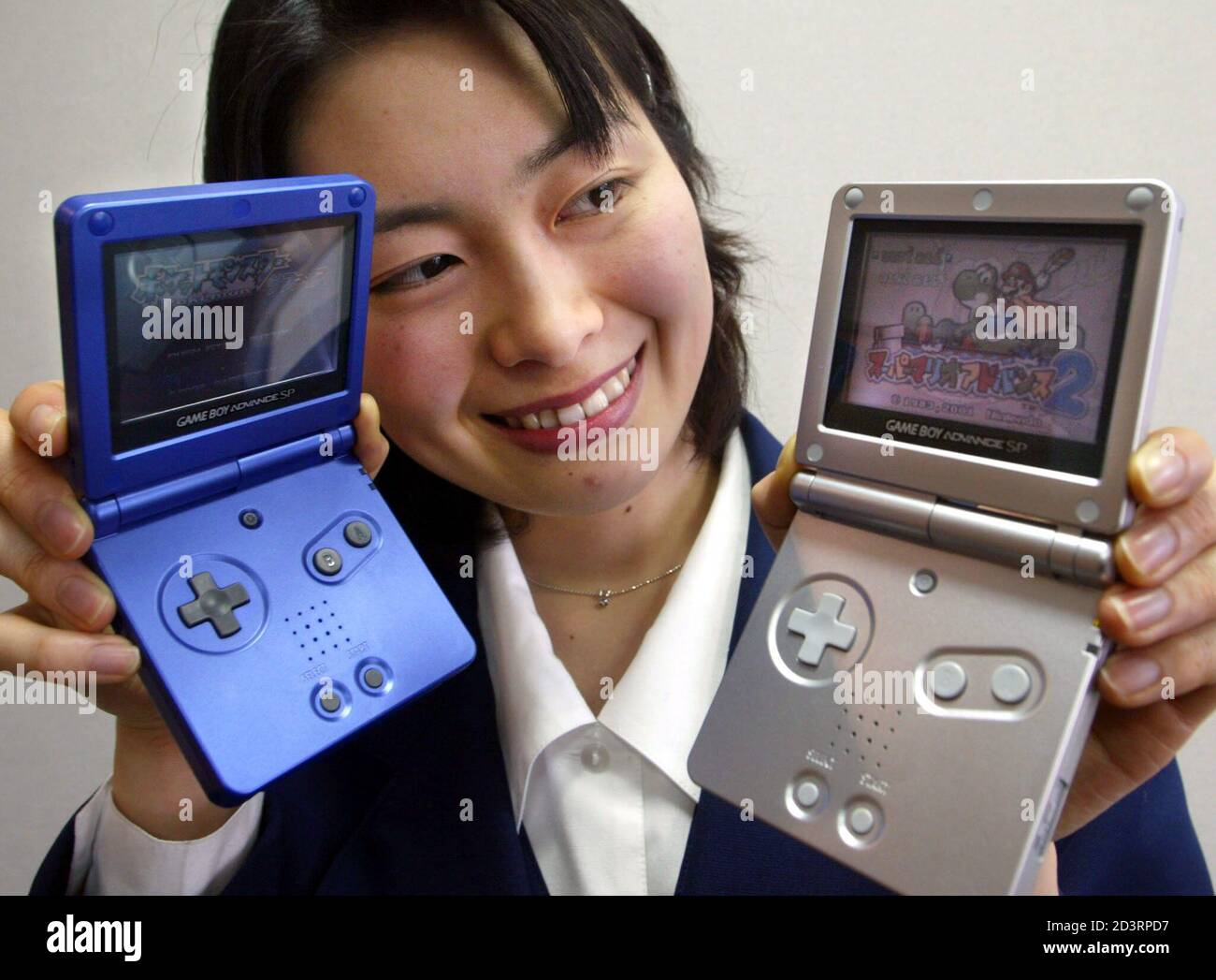 A Nintendo Co employee shows off the company's premium version of its Game  Boy Advance hand-held videogame player in Tokyo January 8, 2003. Japan's  videogame giant said on Tuesday that it would