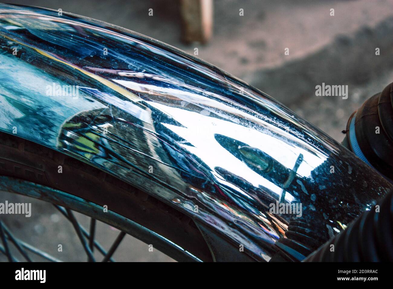 Closeup of a motorcycle rolling in the streets of the city center of