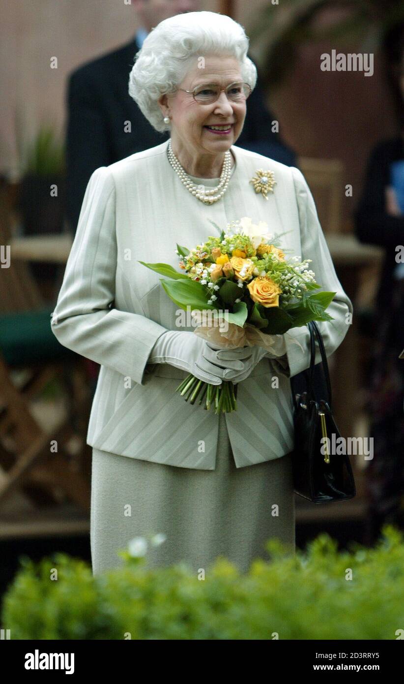 Britain's Queen Elizabeth II examines exhibits during her visit to the Royal Horticultural Society's Chelsea Flower Show in London May 19, 2003. Thousands of visitors are expected to attend the 81st annual show, organised by the Royal Horticultural Society and held at the Royal Hospital in Chelsea, west London. REUTERS/Stephen Hird  SH/NMB Stock Photo
