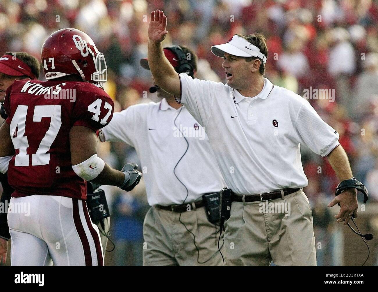 University of Oklahoma Sooners head coach Bob Stoops (R) cheers his team as  Sooners running back Renaldo Works leaves the field during second half  action at Owen Field in Norman, Oklahoma, November
