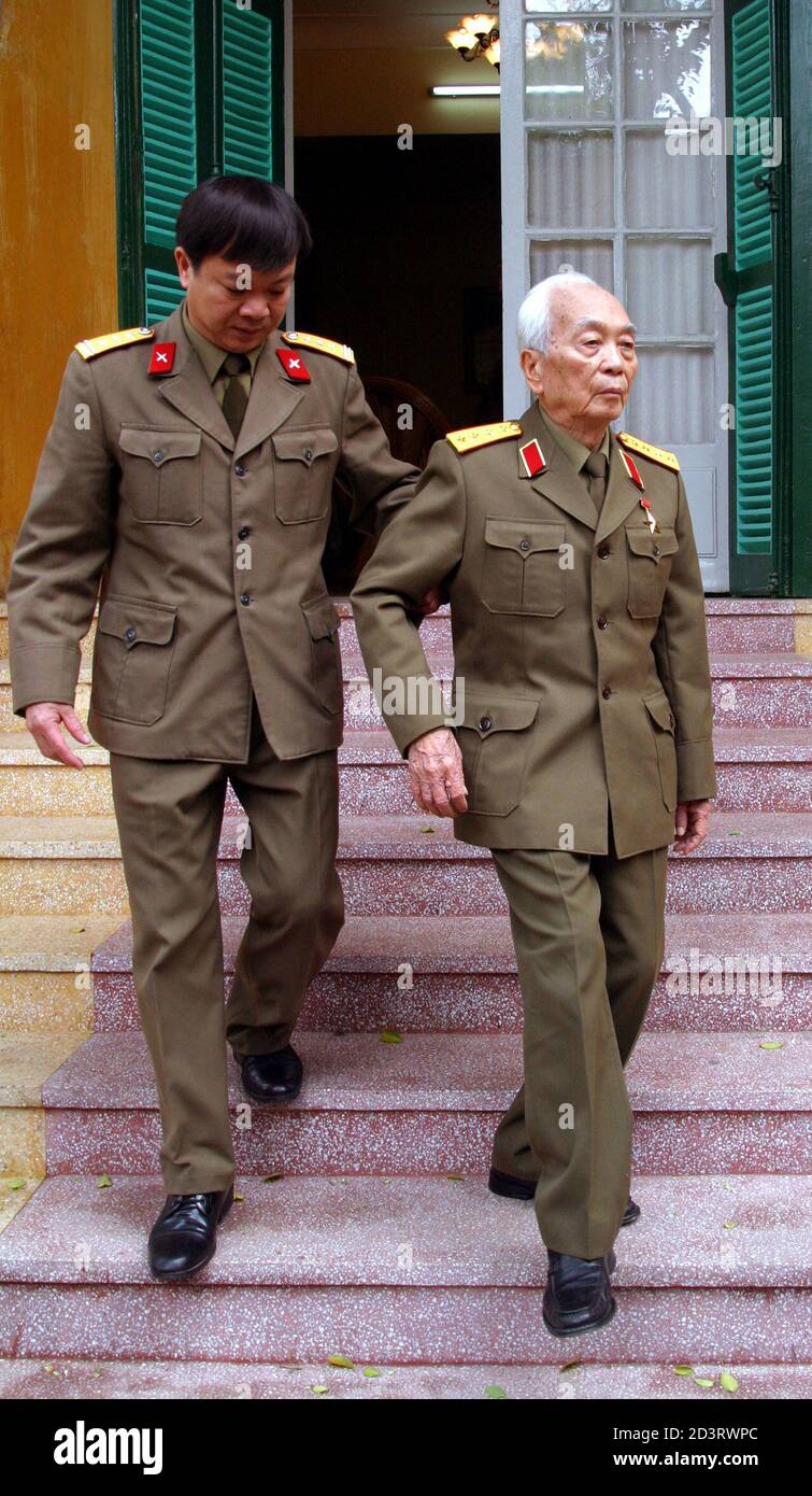 Vietnamese General Vo Nguyen Giap (R), 92, is assisted by his aide, Nguyen  Van Loi, at his residence in Hanoi March 16, 2004. Giap is the mastermind  of the historic defeat of