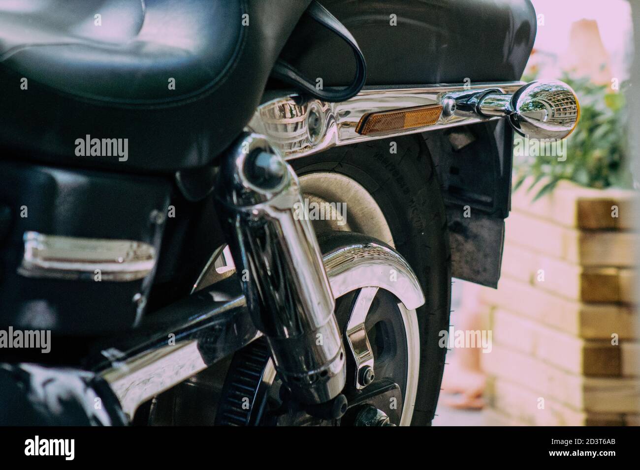 Closeup of a motorcycle rolling in the streets of the city center of