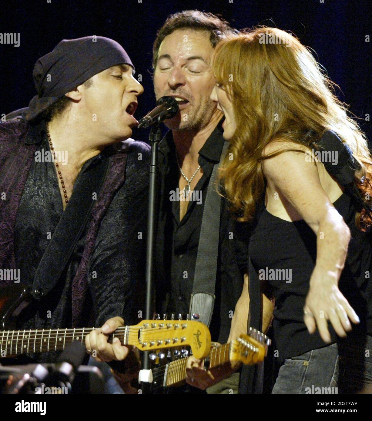 Rock and roll musician Bruce Springsteen sings with E Street Band members  Steve Van Zandt (L) and Patty Scialfa at the Convention Center in Asbury  Park, New Jersey on July 30, 2002