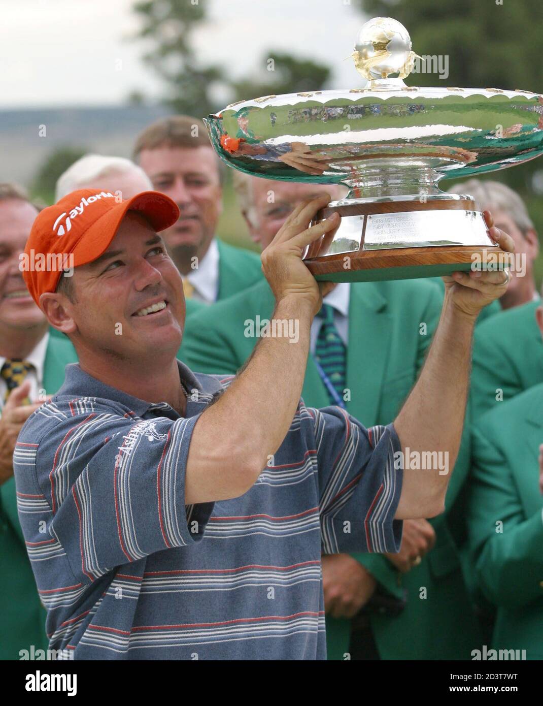 Rich Beem of the United States hoists the winners cup at the International at Castle Pines Golf Club in Castle Rock, Colorado, August 4, 2002. Beem edged out Steve Lowrey 44-43 in the modified Stableford scoring to win the International. REUTERS/Gary C. Caskey  GCC/SV Stock Photo