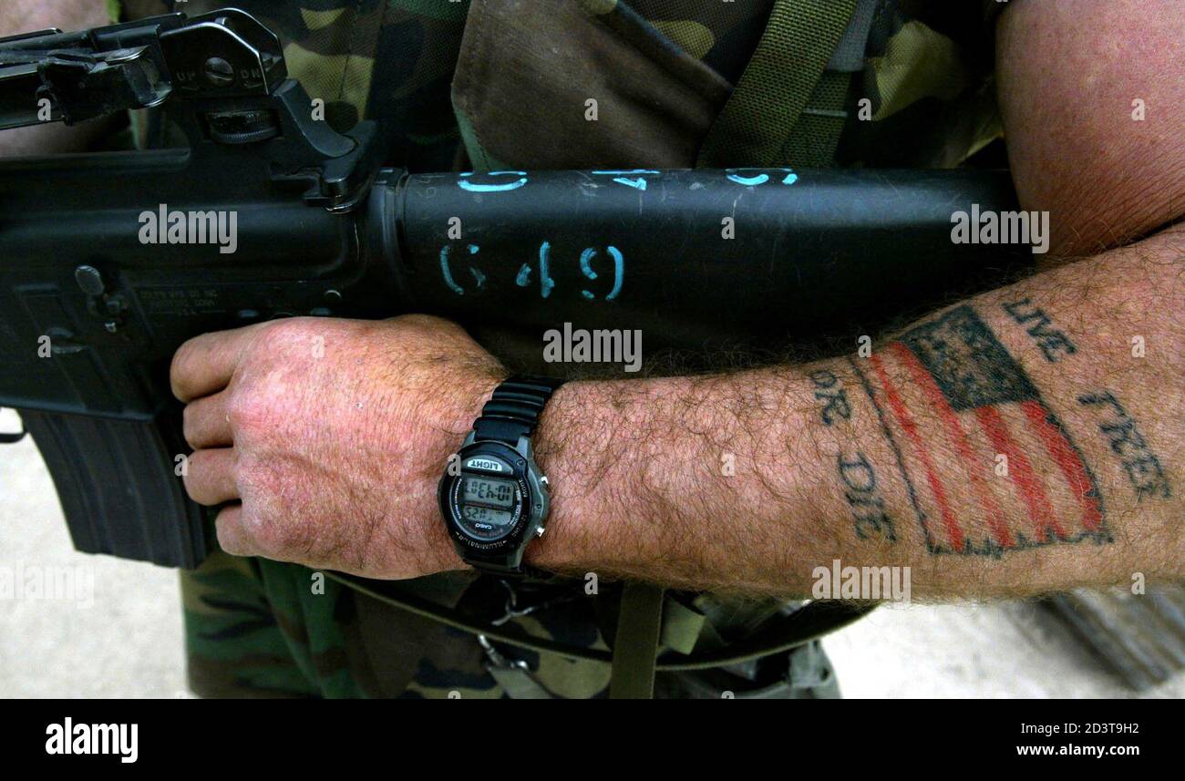 A US soldier bares a tattooed arm while carrying his weapon as he patrols a water treatment plant in the southern Iraq town of Umm Qasr March 25, 2003. Iraq's southern port A US soldier bares a tattooed arm while carrying his weapon as he patrols a water treatment plant in the southern Iraq town of Umm Qasr March 25, 2003. Iraq's southern port