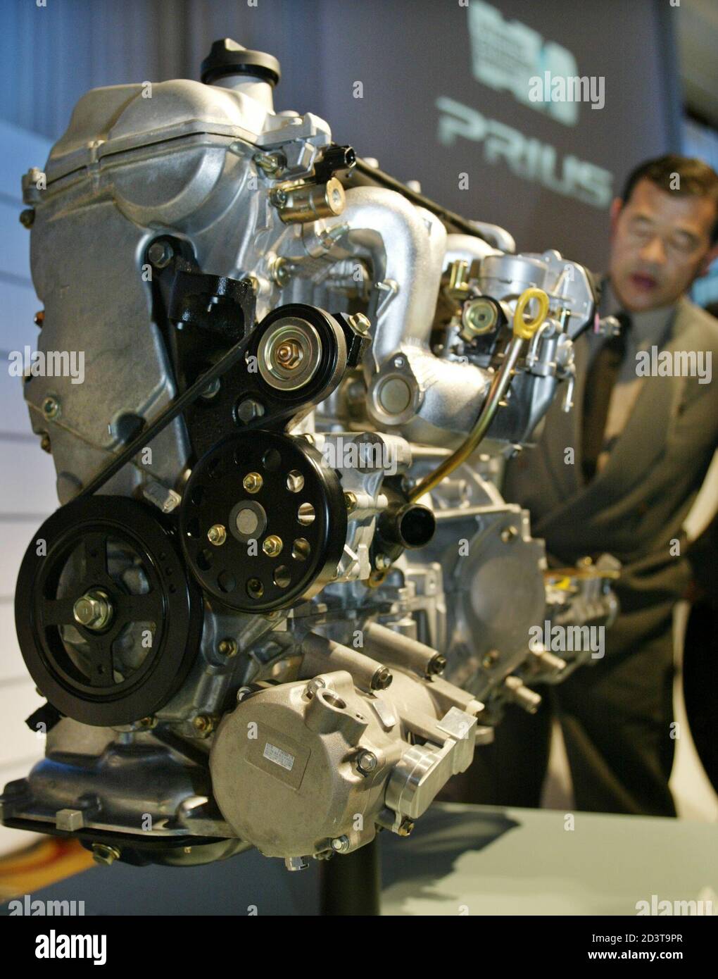 2 PIC:TOK61D  Toyota Motor Corp. displays hybrid system THS II during an unveiling of the all-new 'Prius' in Tokyo April 17, 2003. The new Prius is equipped with Toyota's new hybrid system THS II that allows either gas or electric modes as well as a mode in which both the gas engine and the electric motor are in operation. REUTERS/Issei Kato Stock Photo