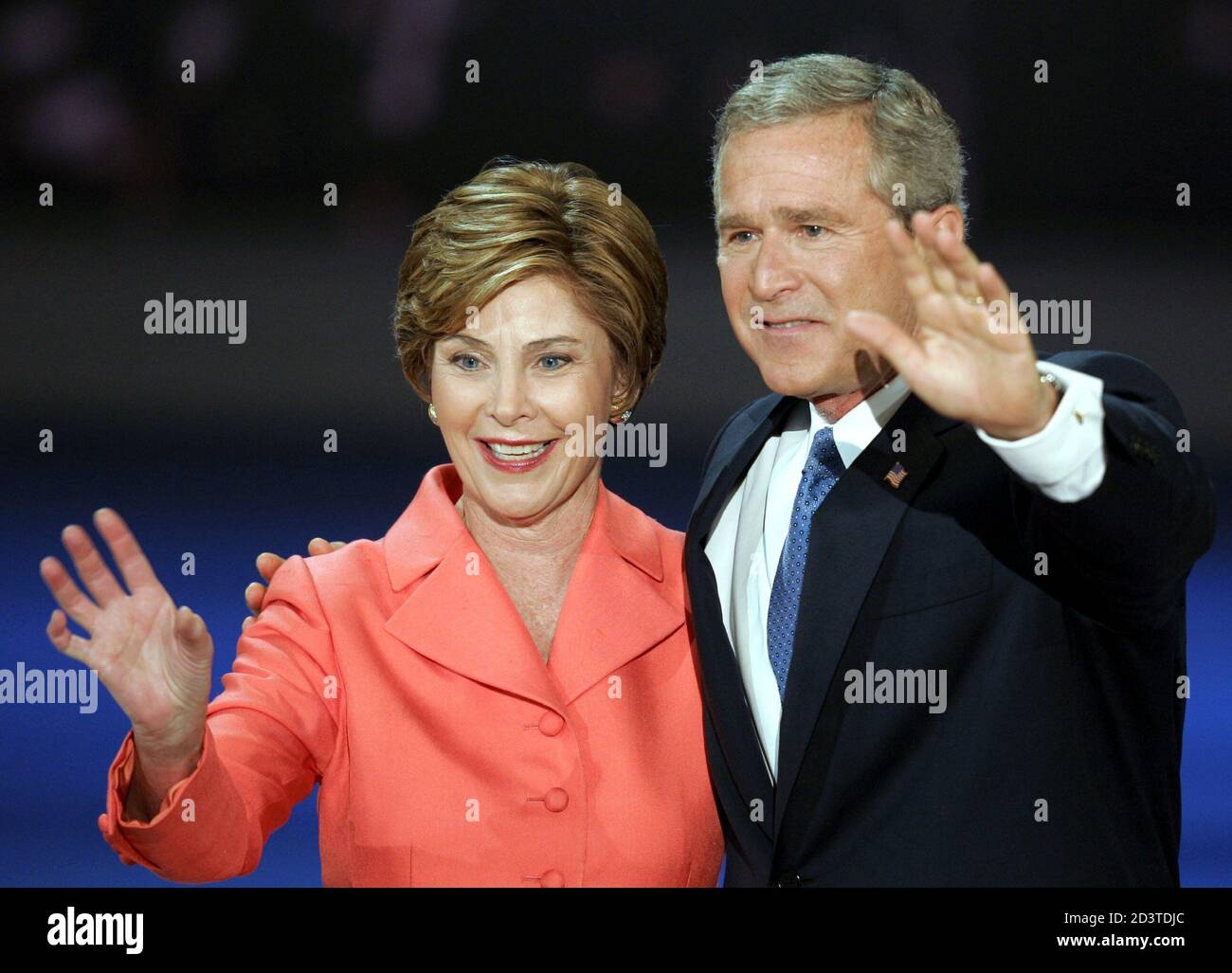 U.S. President George W. Bush and first lady Laura Bush wave to the crowd after addressing the final night of the 2004 Republican National Convention at Madison Square Garden in New York, September 2, 2004. [Bush vigorously defended his first four years in office on Thursday, promising to create a safer world and vowing: 'I will never relent in defending America -- whatever it takes.'] Stock Photo