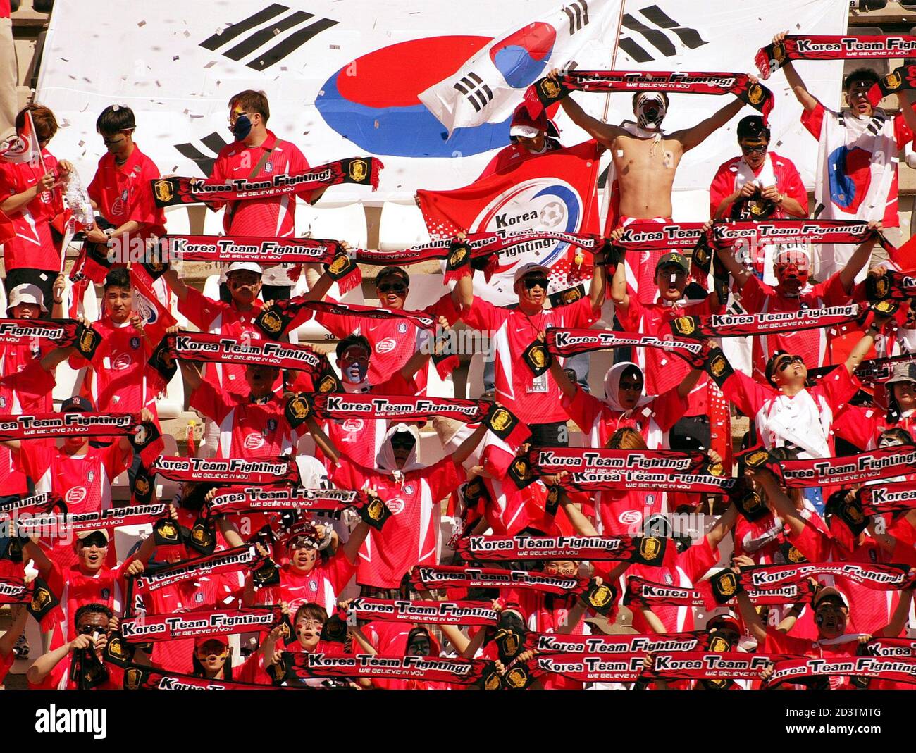 South Korean supporters cheer their team during a friendly soccer match against Finland March 20, 2002 in Cartagena in Eastern Spain. The teams of Korea and Finland are training on the Eastern Spanish coast for the upcoming World Cup. REUTERS/Desmond Boylan DB Stock Photo