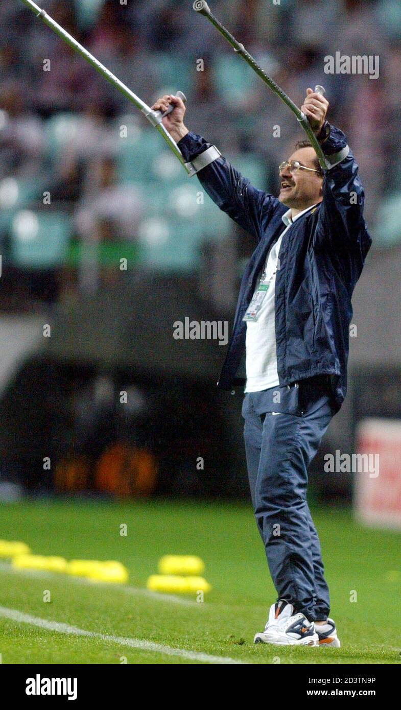 Portugal's head coach Antonio Oliveira celebrates a 4-0 victory over Poland  after their World Cup Finals match in Chonju, June 10, 2002. Oliveira  injured a tendon earlier today and is using crutches