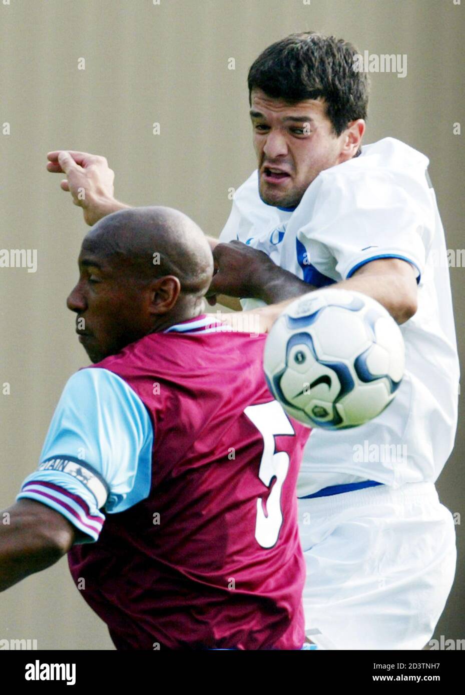 URSAL YASAR AND DION DUBLIN JUMP FOR A HEADER DURING THE UEFA INTERTOTO MATCH FC ZURICH VS. ASTON VILLA.    FC Zurich's Ursal Yasar (R) and Aston Villa's Dion Dublin (L) jump for a header during their UEFA Intertoto third round, first leg soccer match in Zurich on July 21, 2002. REUTERS/Andreas Meier Stock Photo