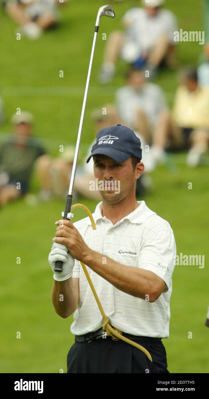 Defending Masters champion Mike Weir of Canada uses a rubber hose to  restrict his swing as he works on the driving range at the Oak Hill Country  Club outside Rochester, New York,