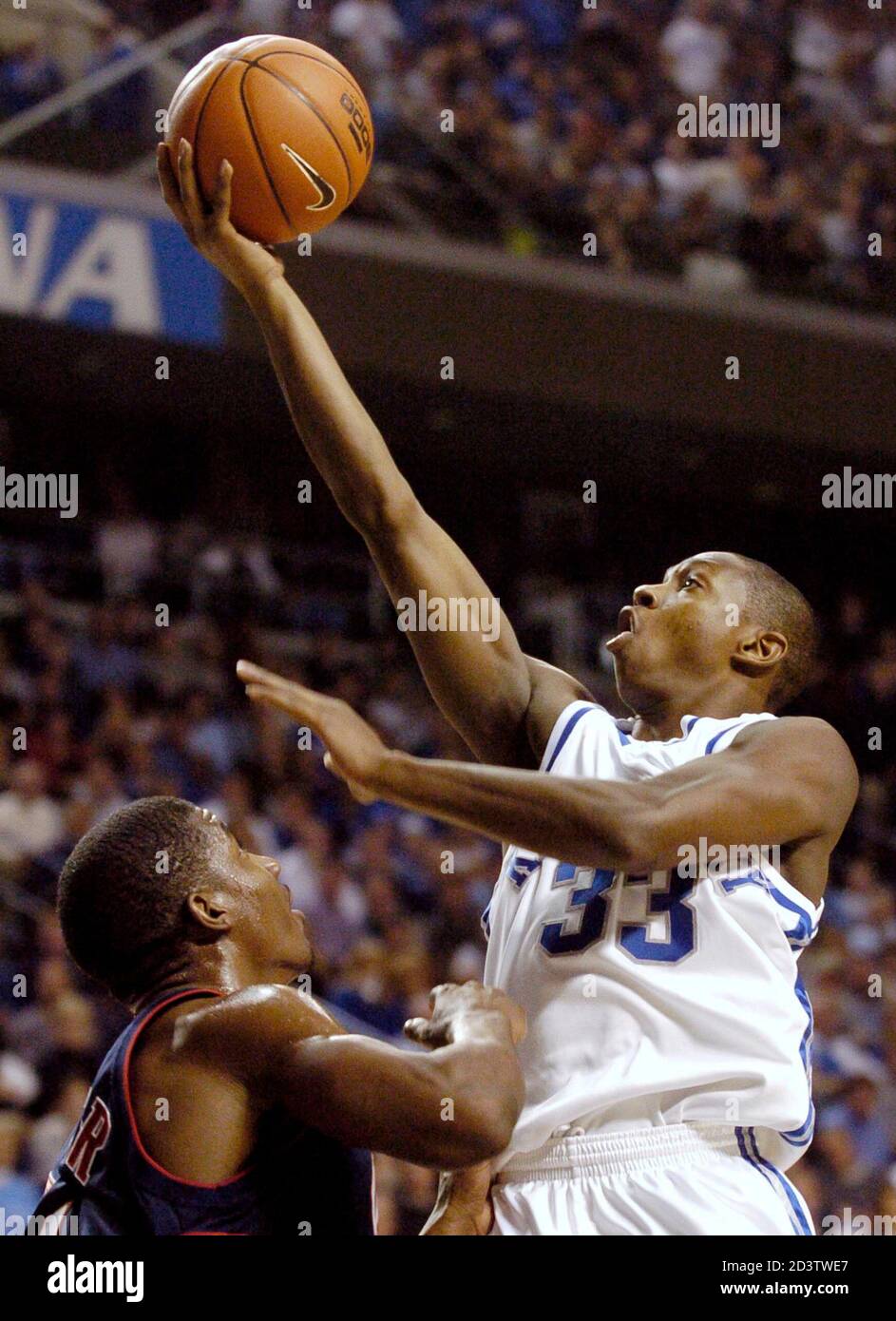 University of Kentucky's Antwain Barbour (R) drives the lane overtop Ole  Miss's Aaron Harper (L) during the first half of play at Rupp Arena in  Lexington, Kentucky, January 28, 2004. REUTERS/ John