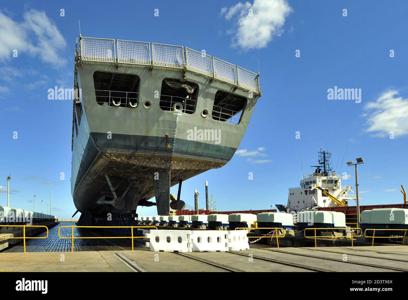 Royal Australian Navy frigate being raised on a synchro lift for periodic servicing. Western Australia, Stock Photo