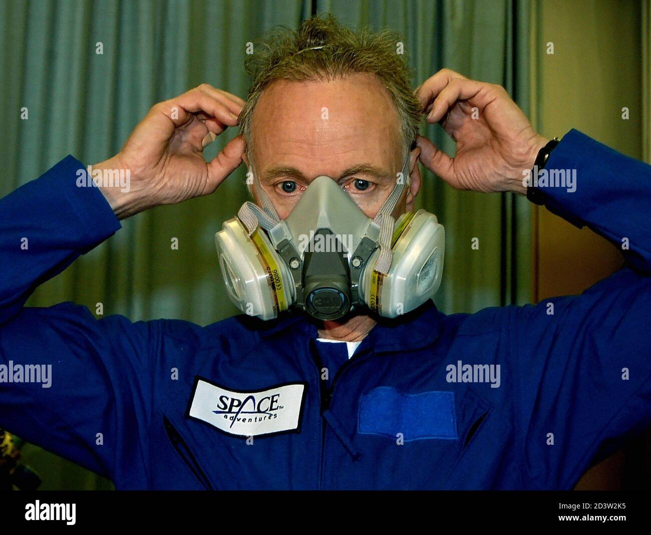American space tourist Olsen tries on an oxygen mask to be used in case of  emergency on board of a space ship during a training in Star City near  Moscow. American space