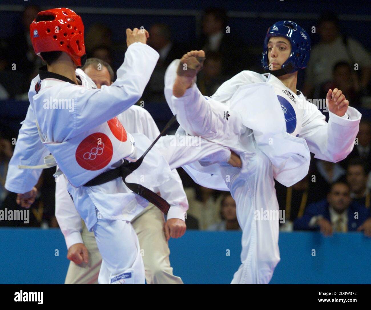 Taiwan's Huang Chih-Hsiung (L) places a kick to Gabriel Alberto Taraburelli  of Argentina in the men's -58 kg Taekwondo final at the Olympic Games in  Sydney on September 27, 2000. Huang won