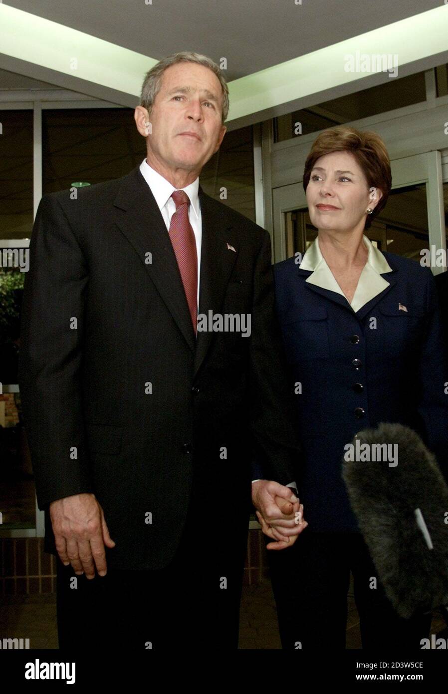 U.S. President George W. Bush and first lady Laura Bush leave Washington Hospital Center September 13, 2001 after paying a visit to some of the most serious victims of the Pentagon attack. Bush told injured Pentagon workers that the country was praying for them, and praised the doctors and nurses caring for victims of Tuesday's terrorist attack. REUTERS/Kevin Lamarque  KL/ME Stock Photo