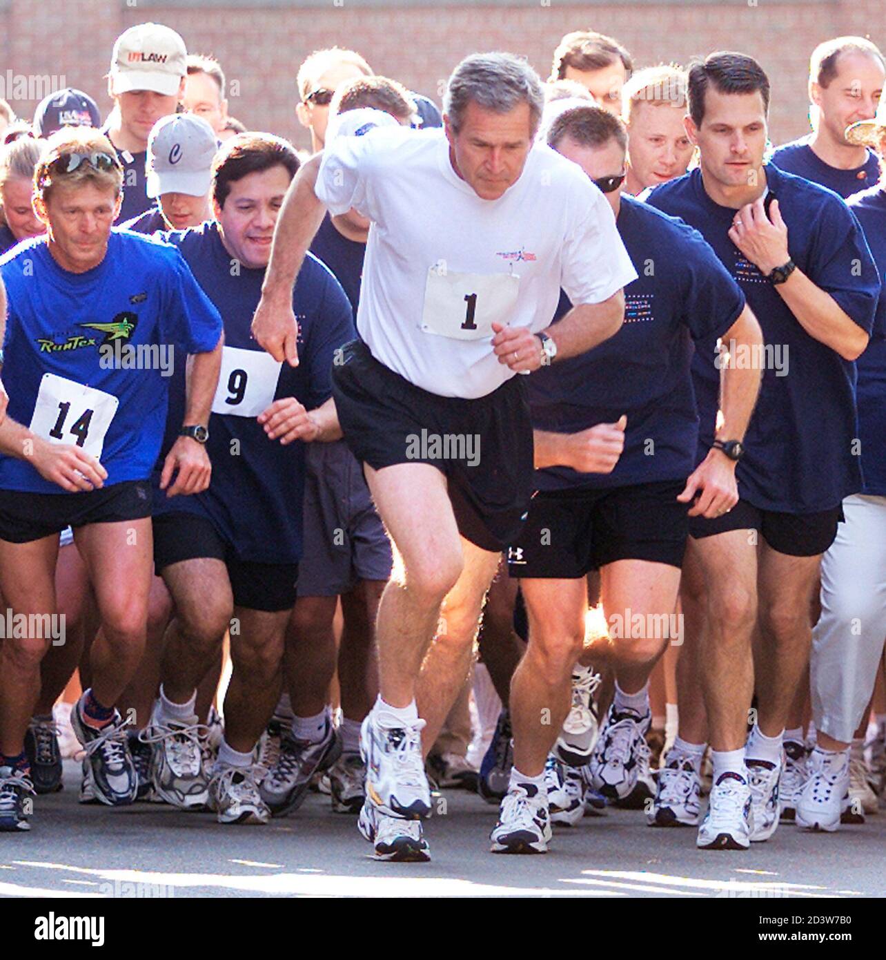 U.S. President George W. Bush (1) participates in The President's Fitness Challenge, a three-mile run at Fort McNair in Washington, June 22, 2002. Bush finished the run at 20 minutes and 28 seconds. The president unveiled his HealthierUS initiative on June 20 which calls for at least a half-hour of exercise every day for adults and more for children, eating smaller portions of more nutritious foods, regular preventative health screenings and avoidance of any risky behaviors, especially involving alcohol, tobacco and illegal drugs. REUTERS/Hyungwon Kang  HK Stock Photo