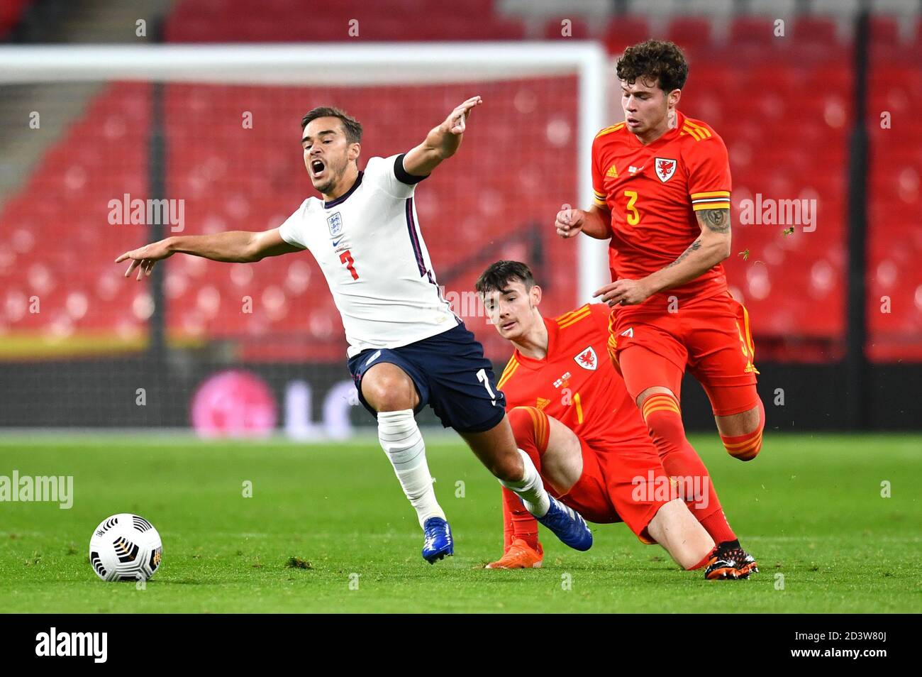 England's Harry Winks (left) and Wales' Dylan Levitt (centre) battle for the ball during the international friendly match at Wembley Stadium, London. Stock Photo