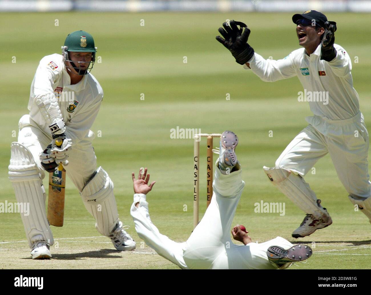 Sri Lankan wicketkeeper Kumar Sangakkar (R) reacts as fielder Russel Premakumaran Arnold dives to catch the ball off South African batsman Graeme Smith (L) on the second day of their test played at Wanderers Stadium, Johannesburg, November 9, 2002. The umpire gave Smith not out. Sri Lanka scored 192 all out in the first innings. REUTERS/Anne Laing  AL/JDP Stock Photo