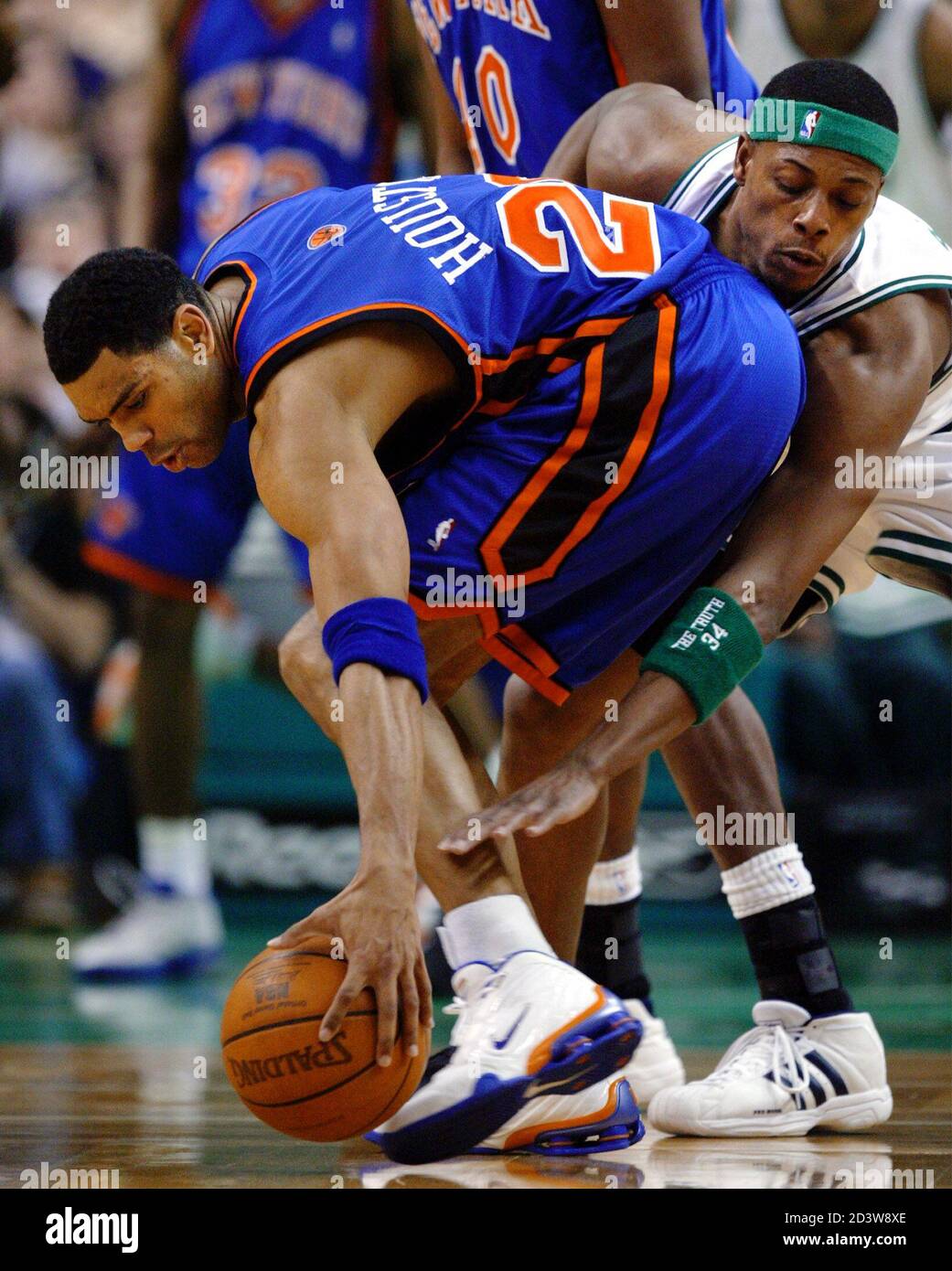 The Boston Celtics' Paul Pierce (R) reaches around the New York Knicks'  Allan Houston to knock the ball away in first quarter NBA action in Boston,  Massachusetts March 5, 2003. REUTERS/Brian Snyder