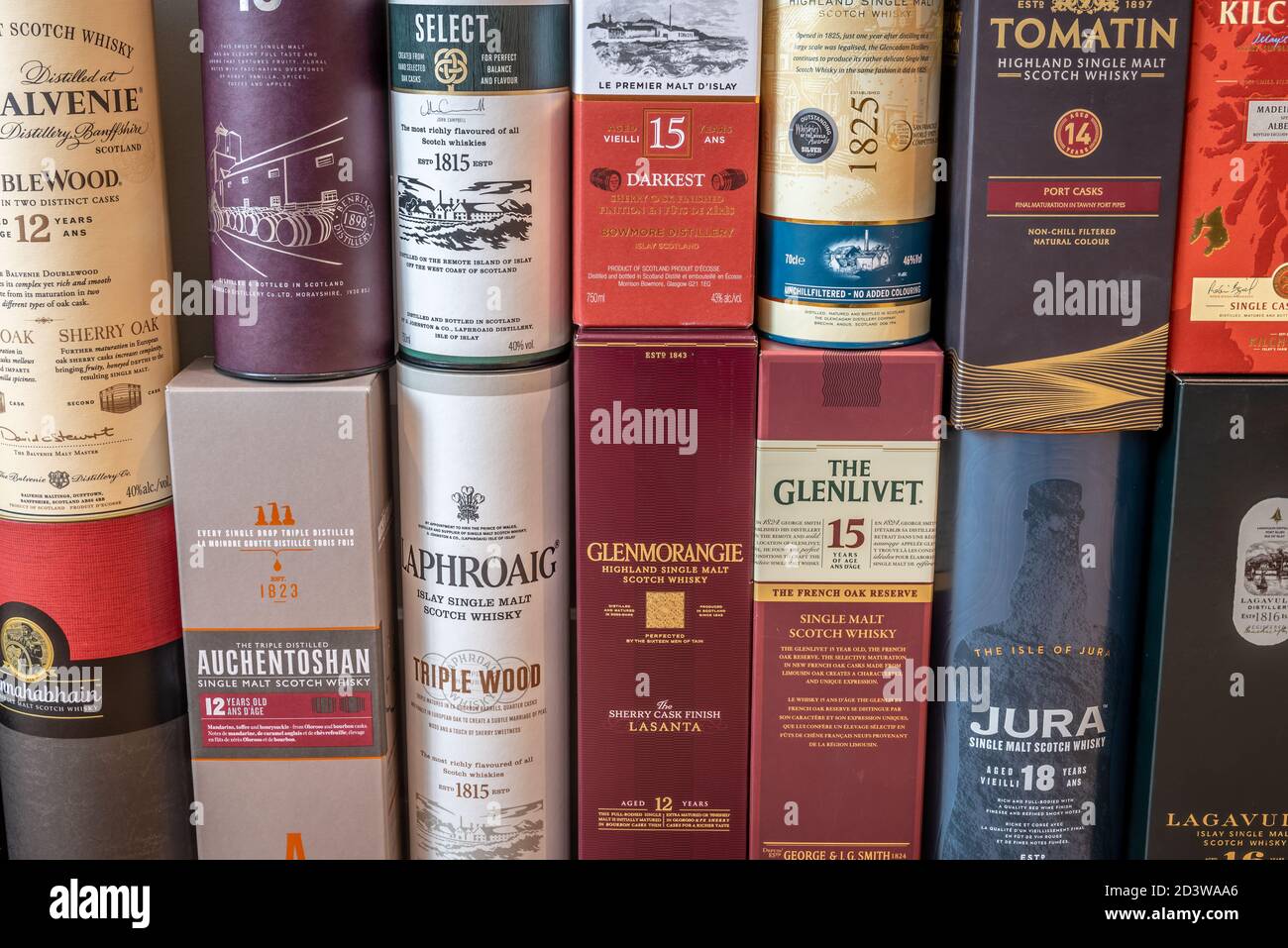 Miscellaneous scotch whisky presentation boxes stacked together to create a background. Stock Photo