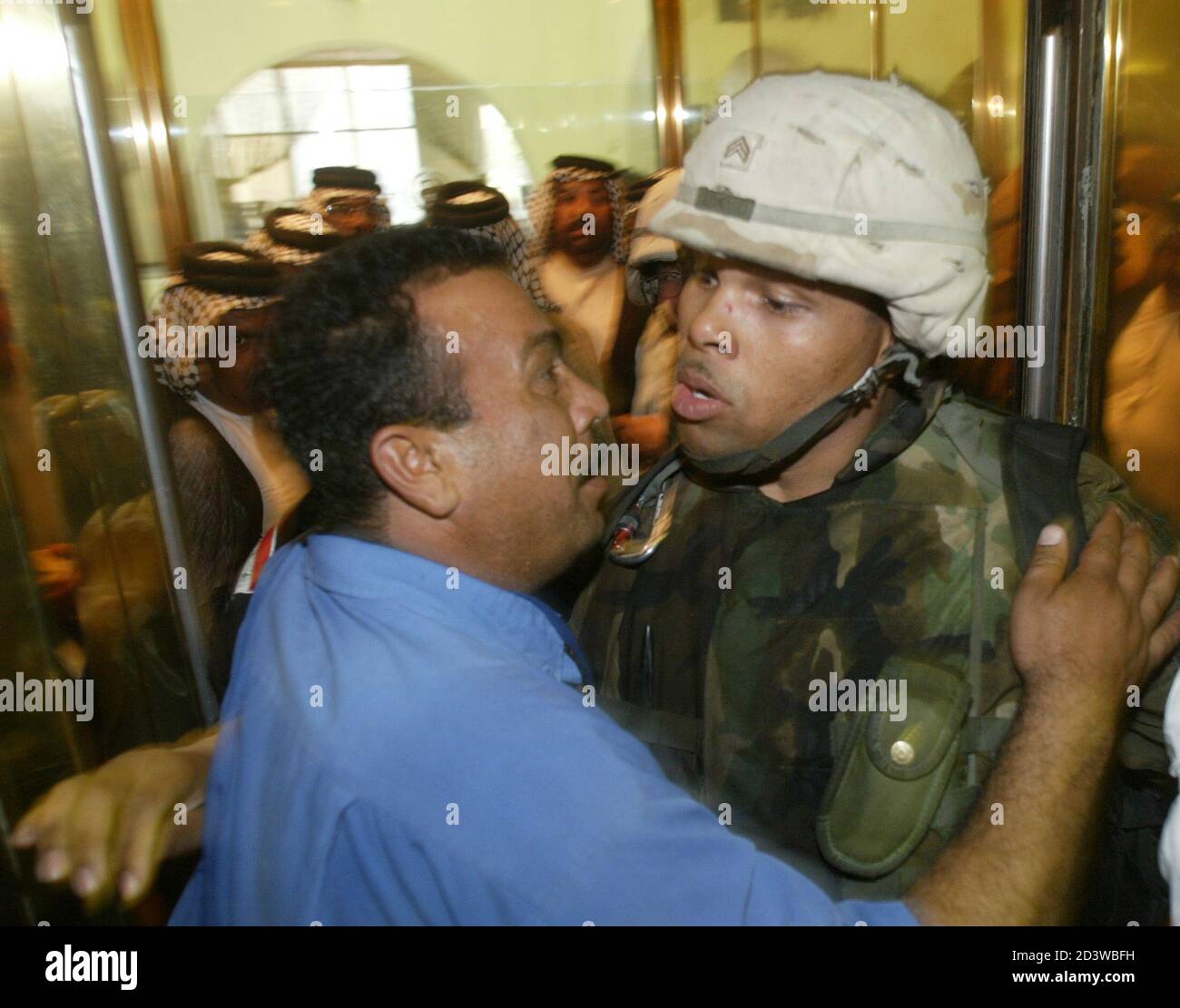 A U.S Army soldier, guarding a Baghdad hotel elevator, is confronted by an  Iraqi man after an aide to radical Shi'ite cleric Moqtada al-Sadr, Hazem  al-Araji, was detained April 13, 2004. Al-Arajj