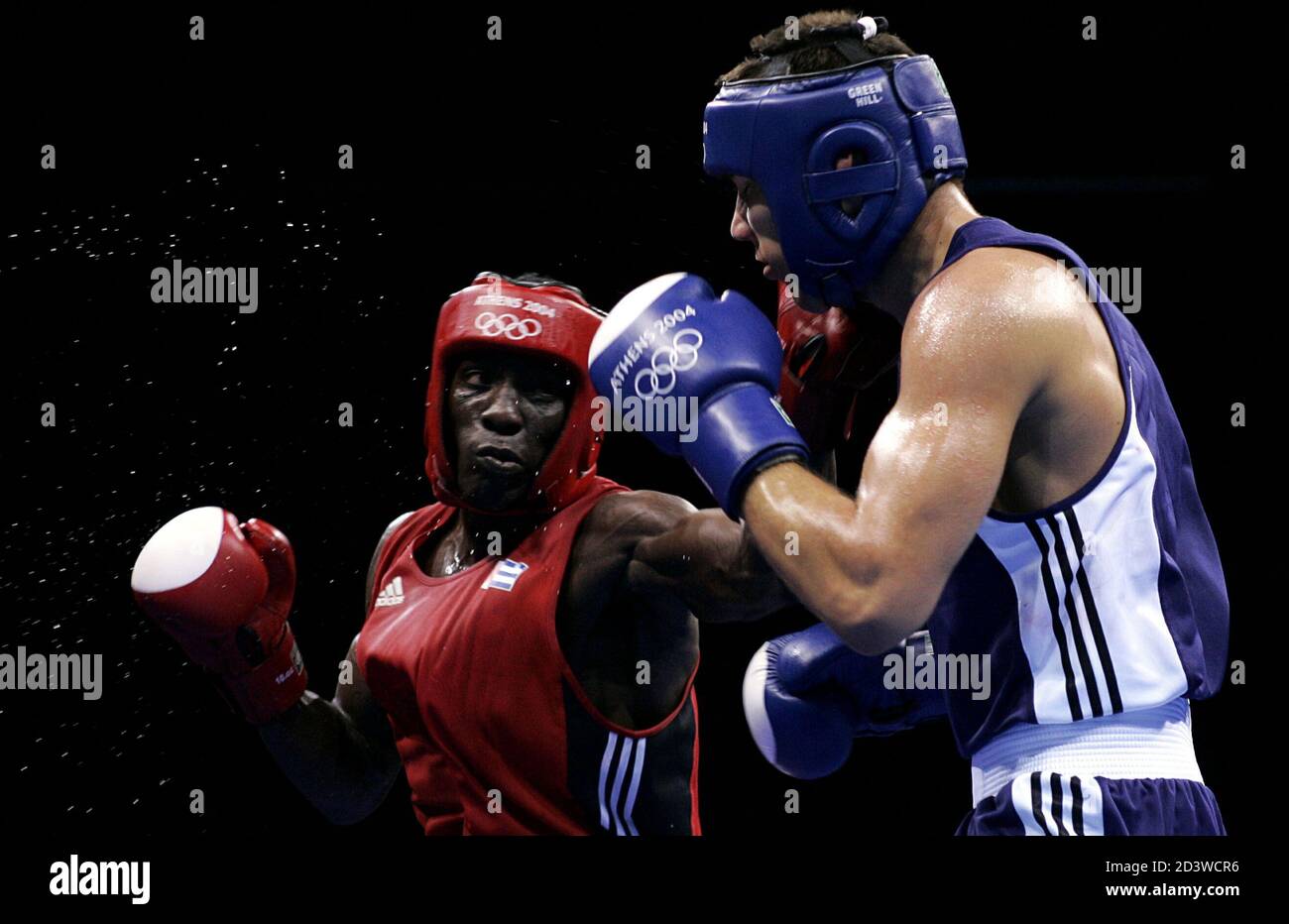 Yordani Despaigne Herrera of Cuba (L) lands a punch on Karoly Balzsay of Hungary during their round of 16 middleweight bout at the Athens 2004 Olympic Summer Games August 21, 2004. Despaigne Herrera won the fight and qualified for the quarter finals. Stock Photo