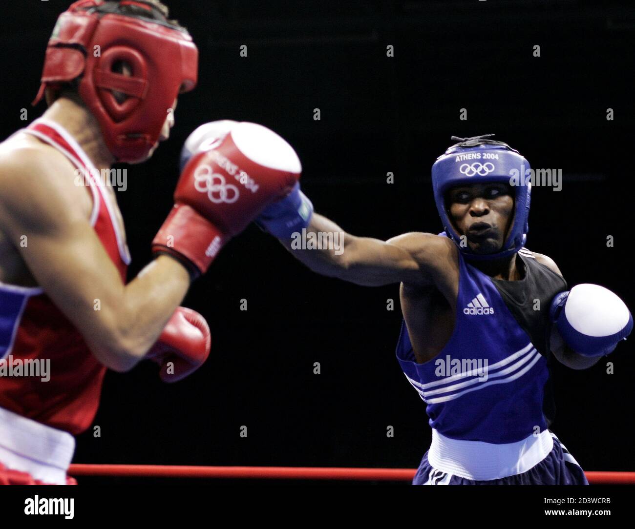 Cuba's Mario Cesar Kindelan Mesa (R) punches Pakistan's Asghar Ali Shan (L) in their light weight (60kg) round of 16 boxing bout at the Athens 2004 Olympic Summer Games, August 20, 2004. Cesar Kindelan Mesa won the bout. Stock Photo