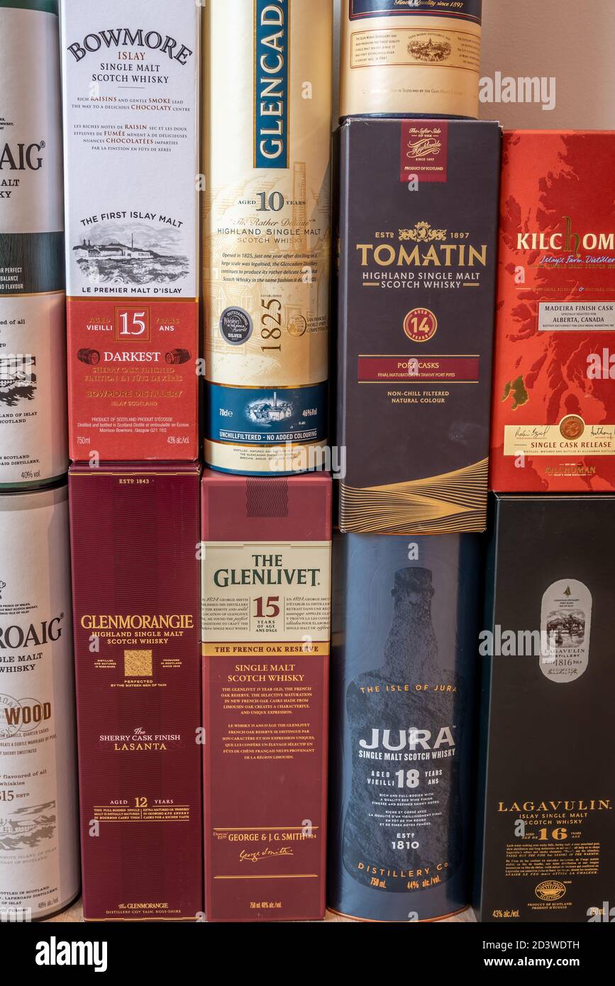 Miscellaneous scotch whisky presentation boxes stacked together to create a background. Stock Photo